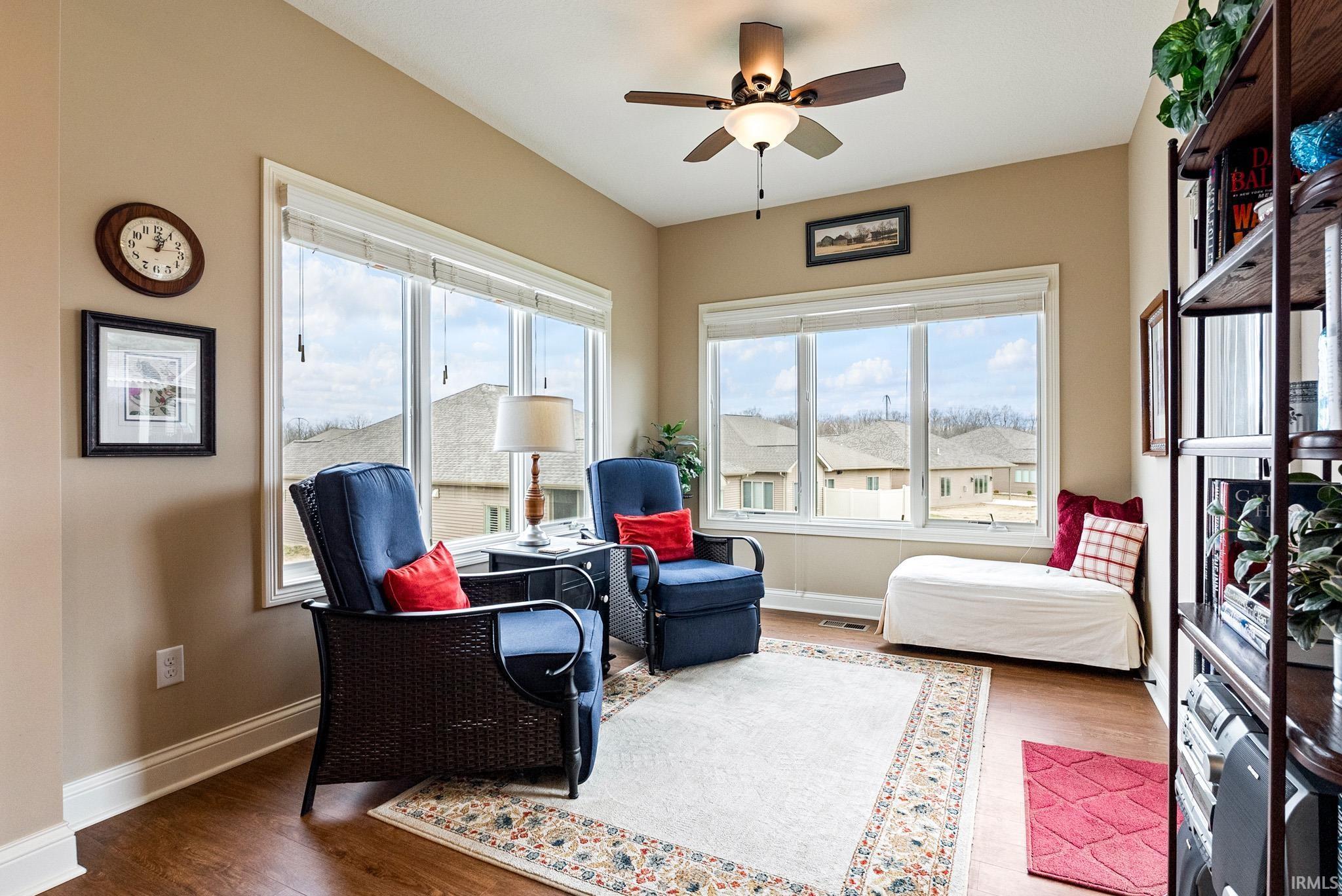 Living area featuring wood finished floors and a ceiling fan