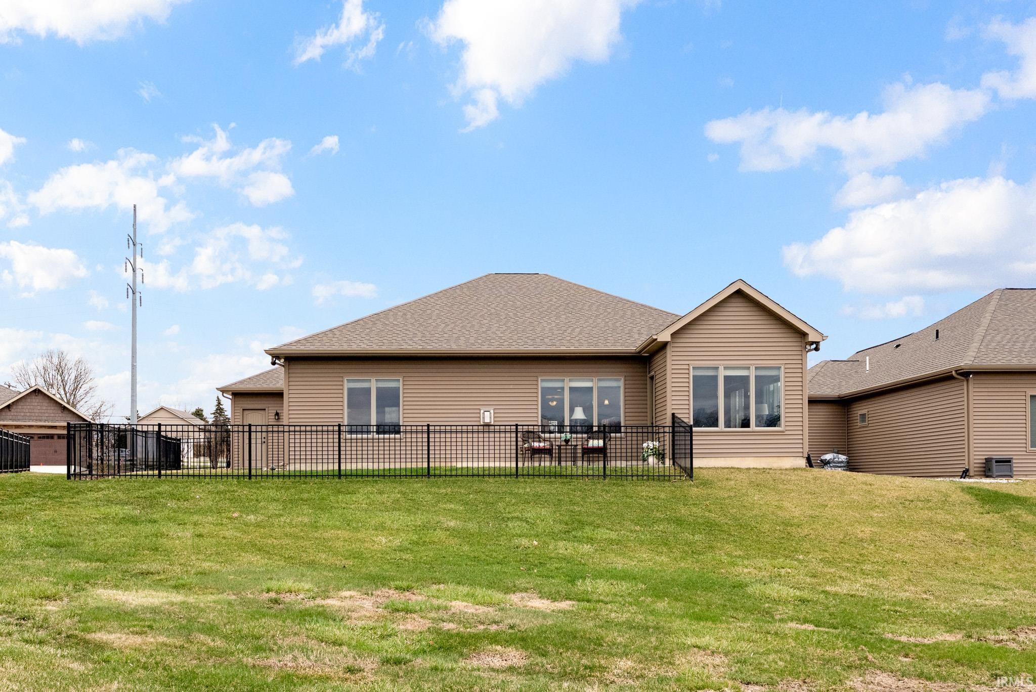 Back of property featuring roof with shingles
