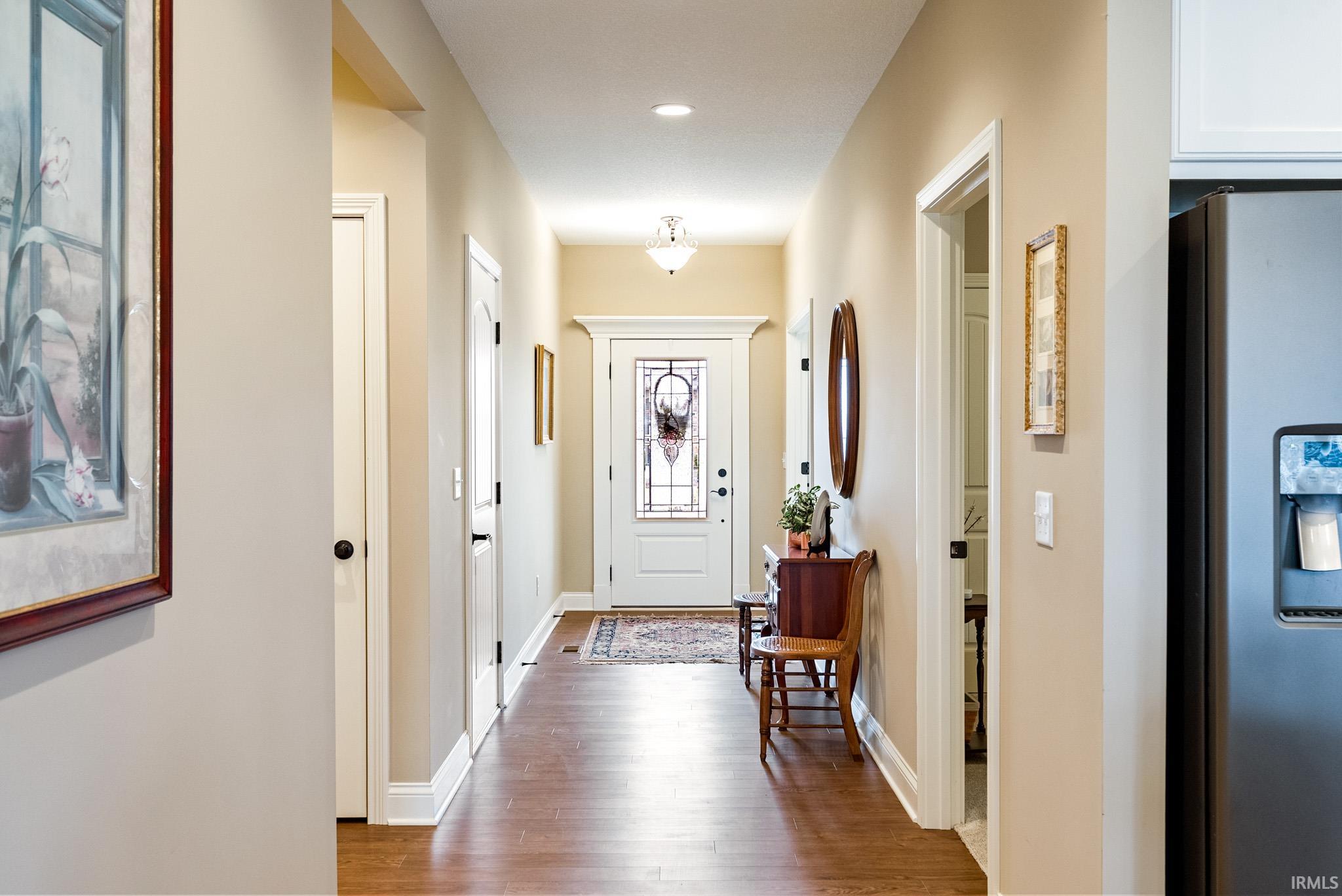Entryway with light wood finished floors and baseboards