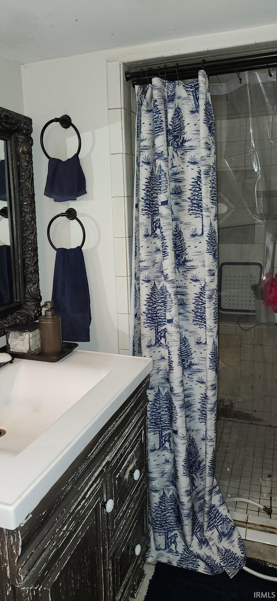 Full bathroom featuring vanity and a stall shower