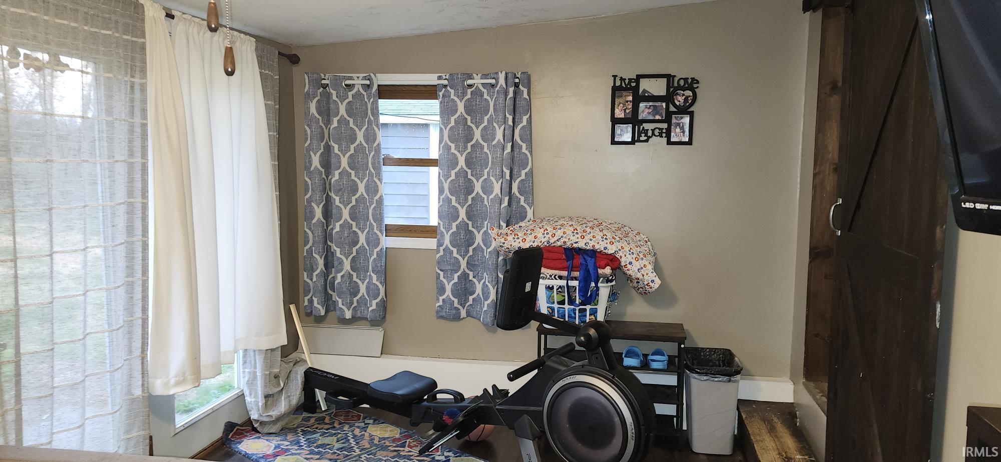 Bathroom featuring healthy amount of natural light, lofted ceiling, and dark wood-type flooring