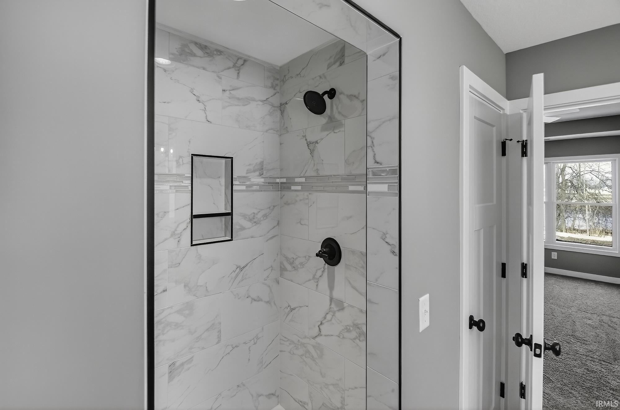Bathroom featuring a marble finish shower