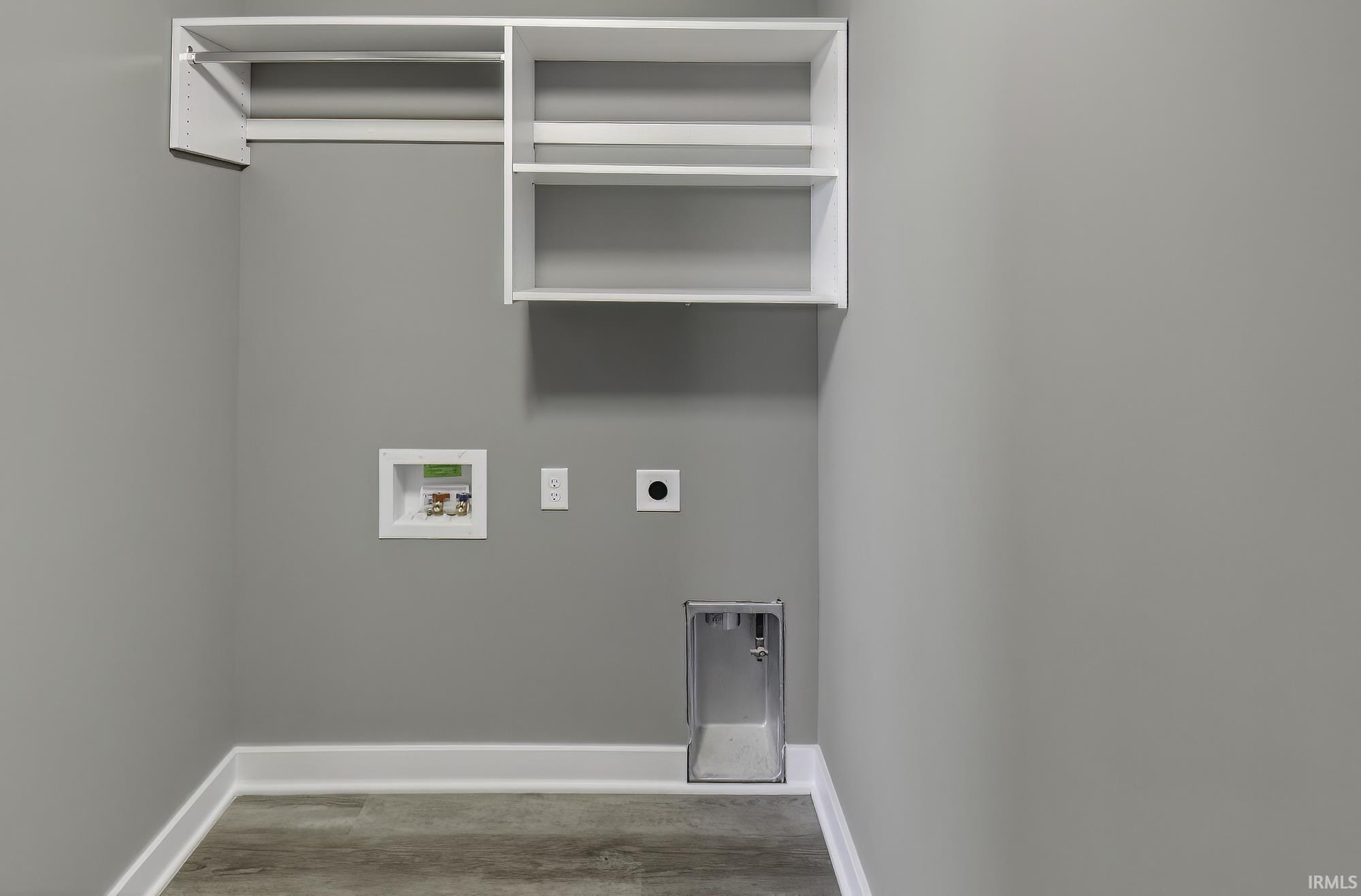 Laundry room with hookup for an electric dryer, wood finished floors, and hookup for a washing machine