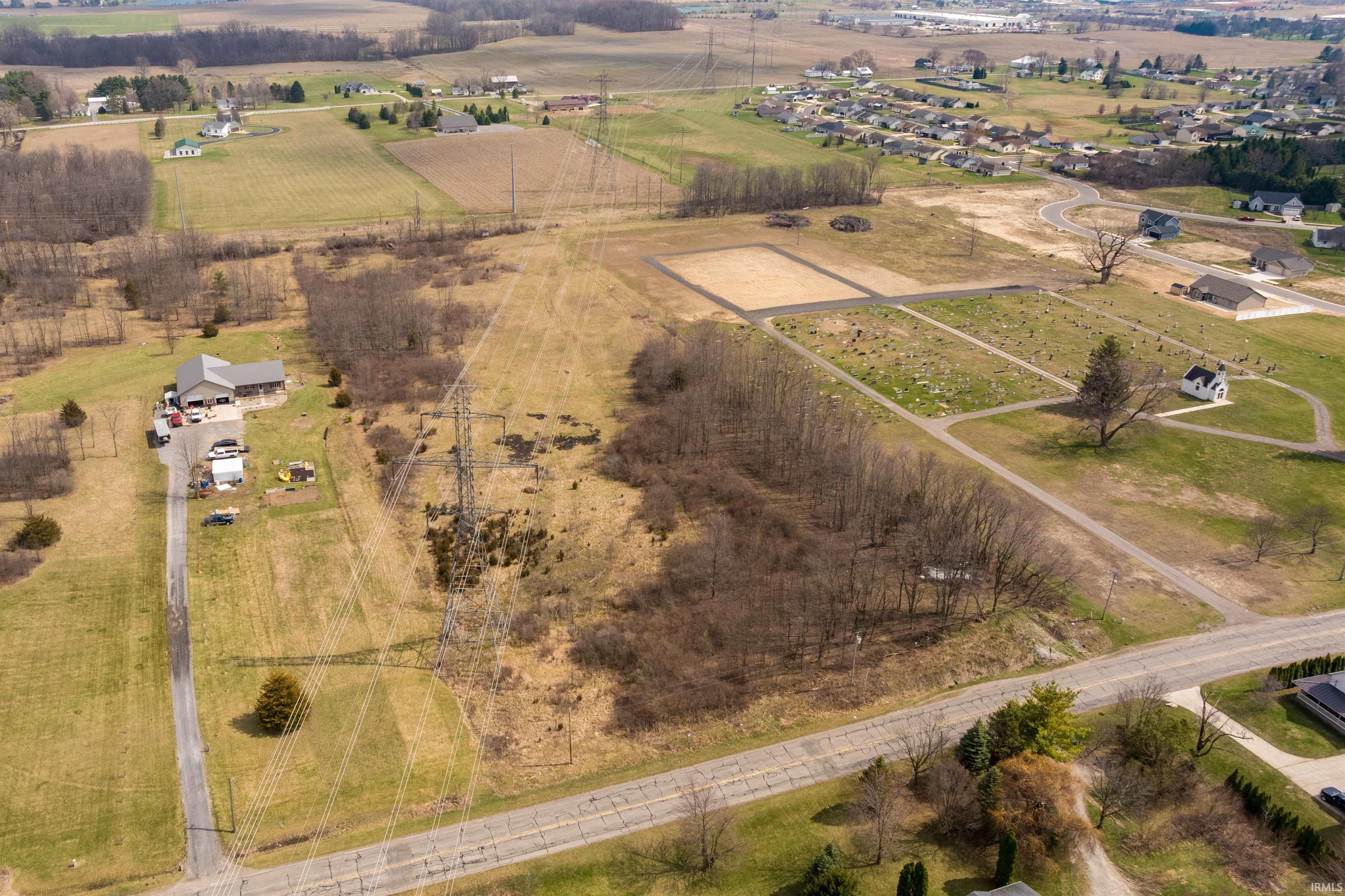 Aerial overview of property's location with rural landscape and large plots for crops
