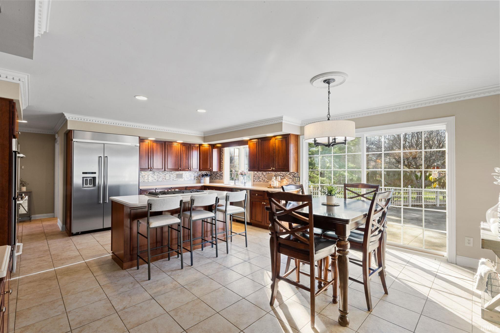 Dining room featuring crown molding, light tile patterned flooring, and recessed lighting