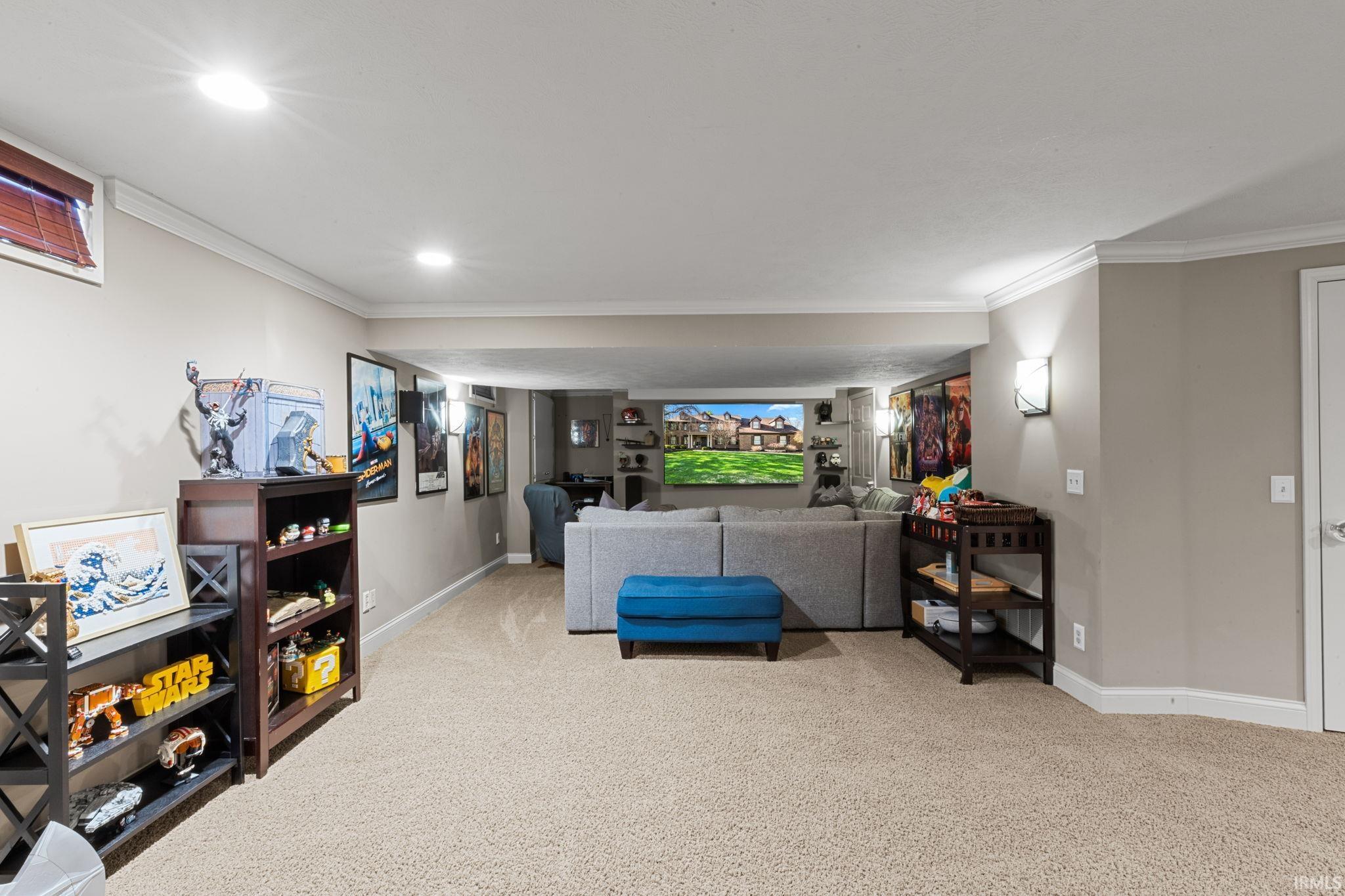 Sitting room with ornamental molding, carpet floors, and recessed lighting