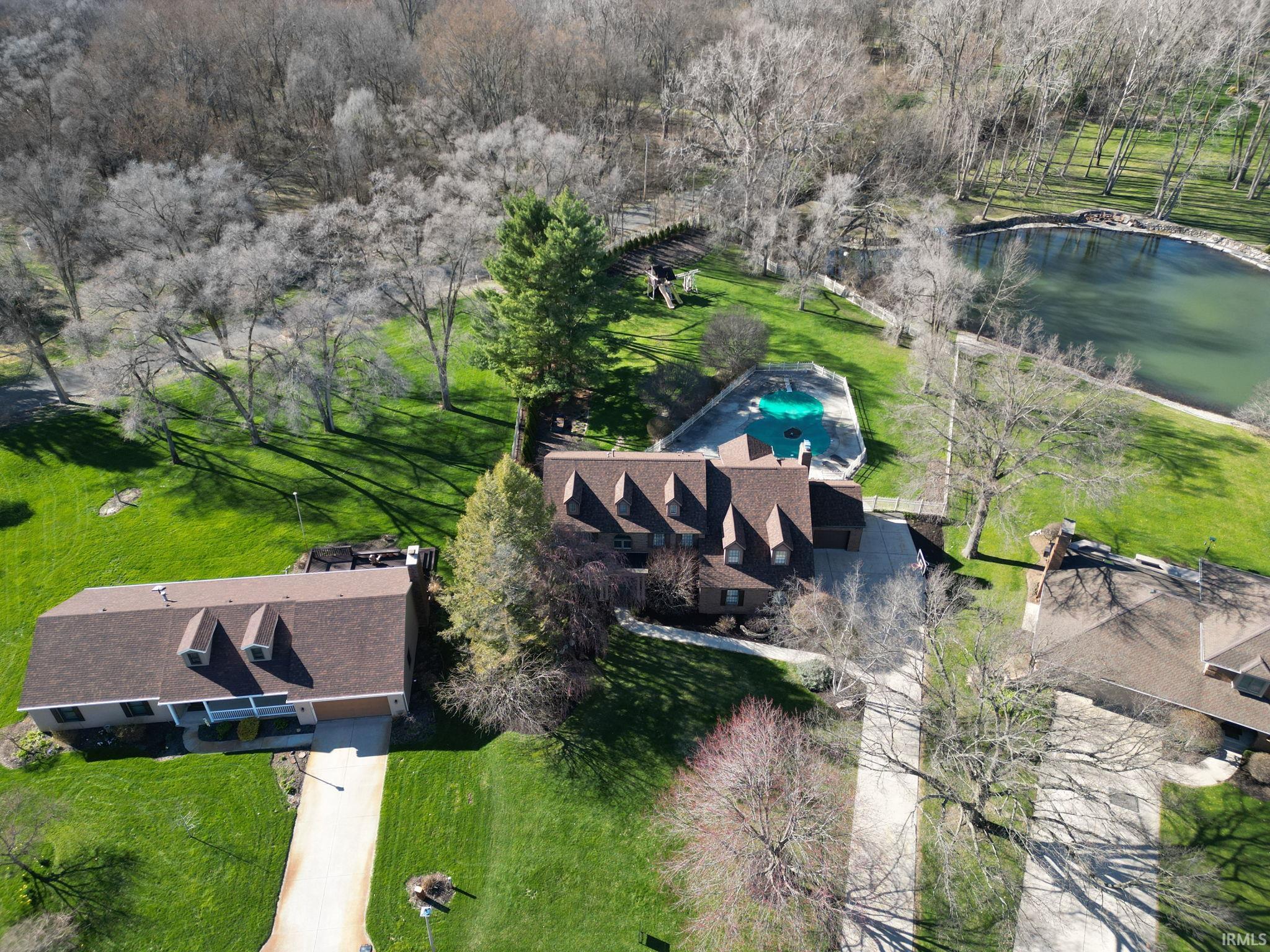 View of subject property featuring a large body of water and a pool