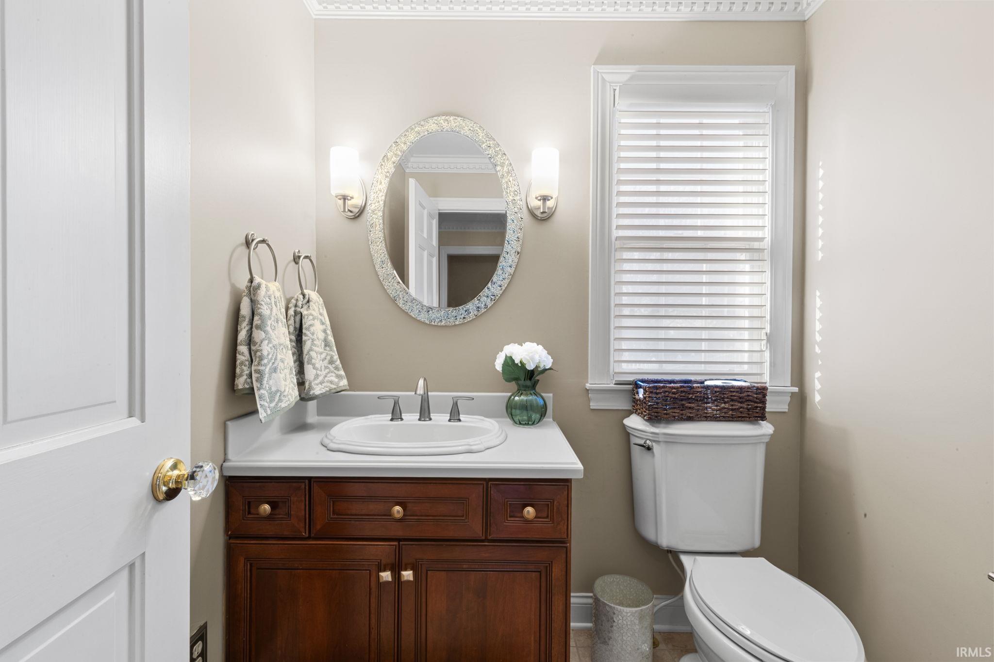 Half bathroom featuring vanity and toilet