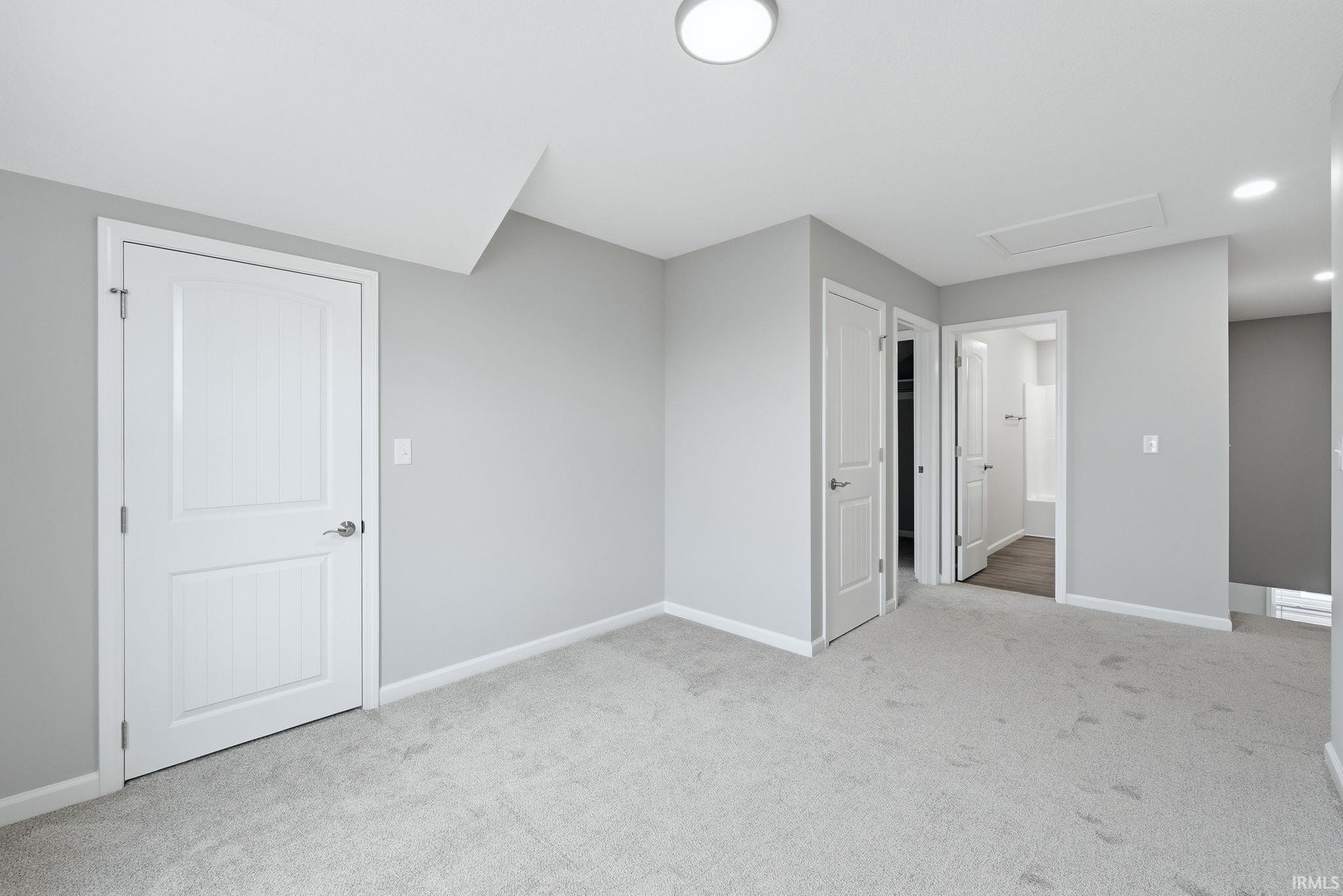 Unfurnished bedroom featuring light colored carpet and recessed lighting
