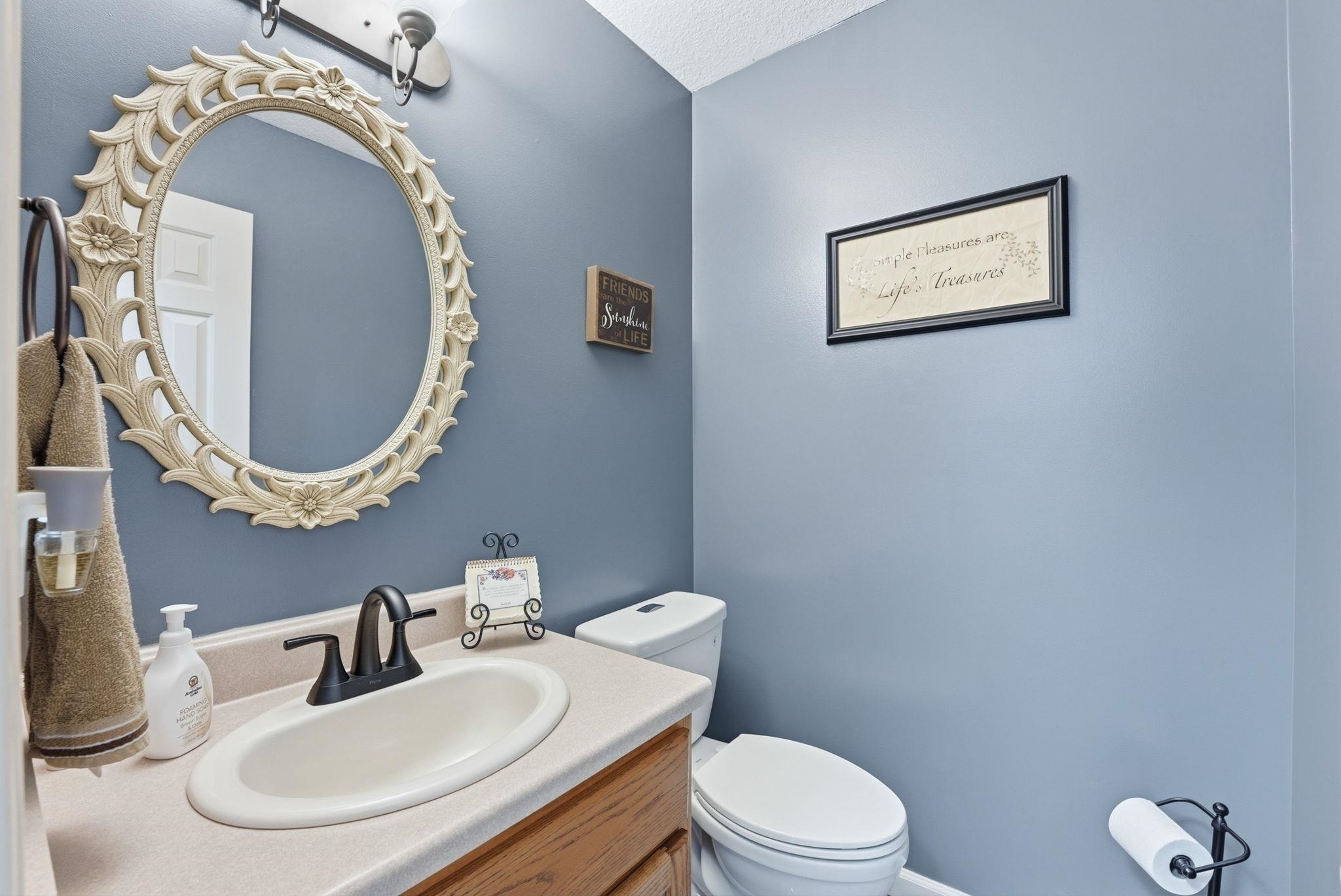 Half bath with vanity and toilet