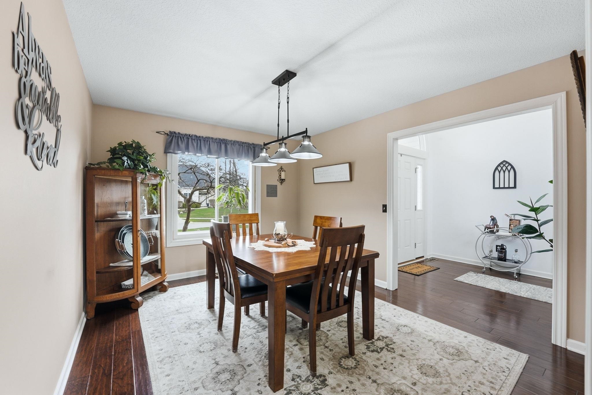 Dining space featuring dark wood finished floors and baseboards
