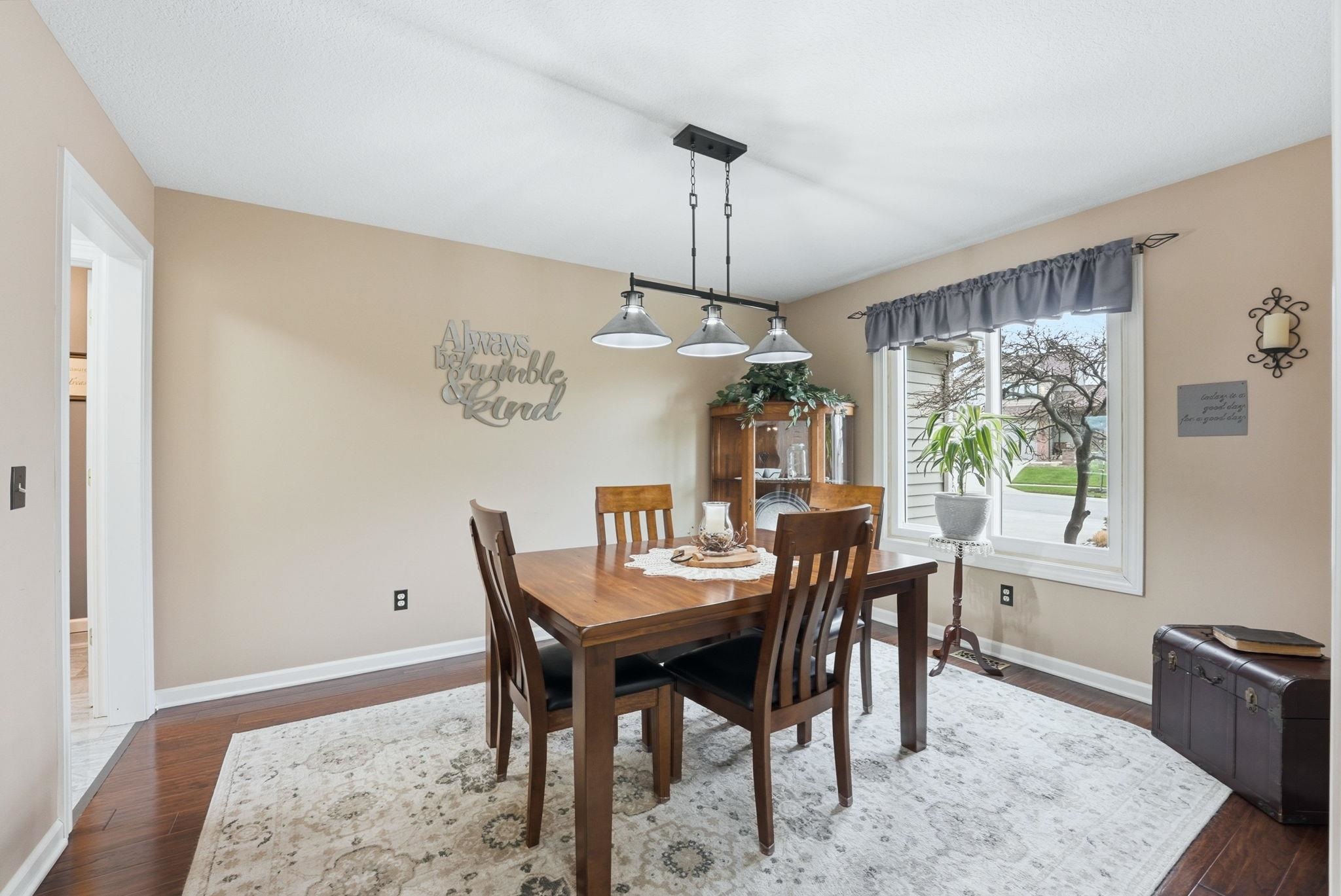 Dining room with baseboards and dark wood-style flooring