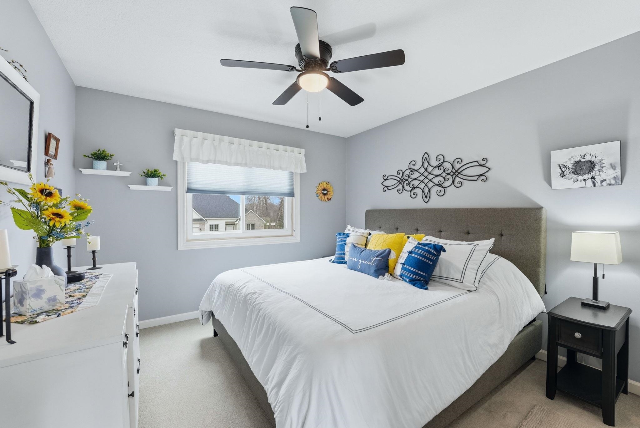 Bedroom featuring light carpet and a ceiling fan