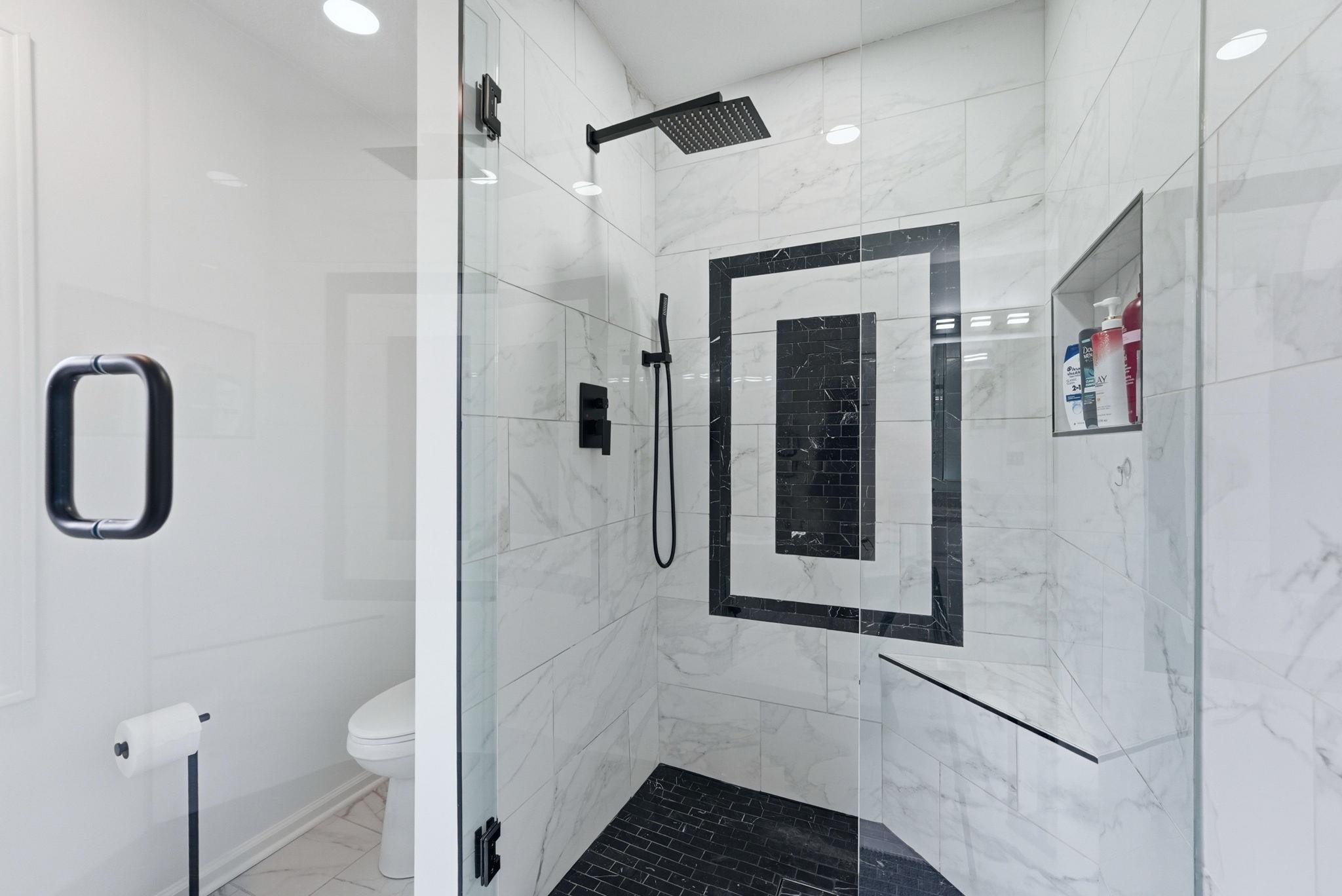 Full bathroom with a marble finish shower and light marble finish floors