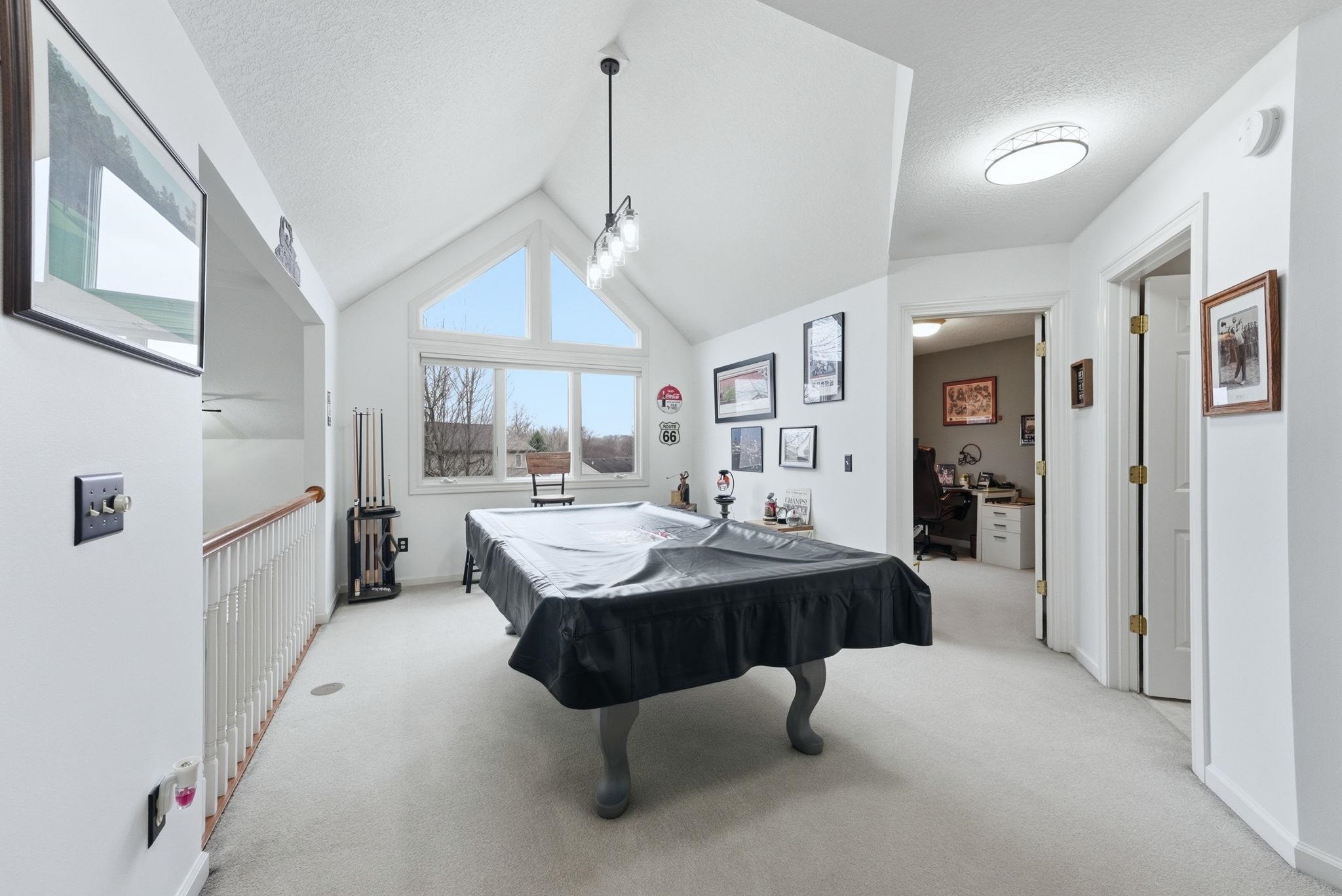 Playroom featuring pool table, light carpet, and a high textured ceiling