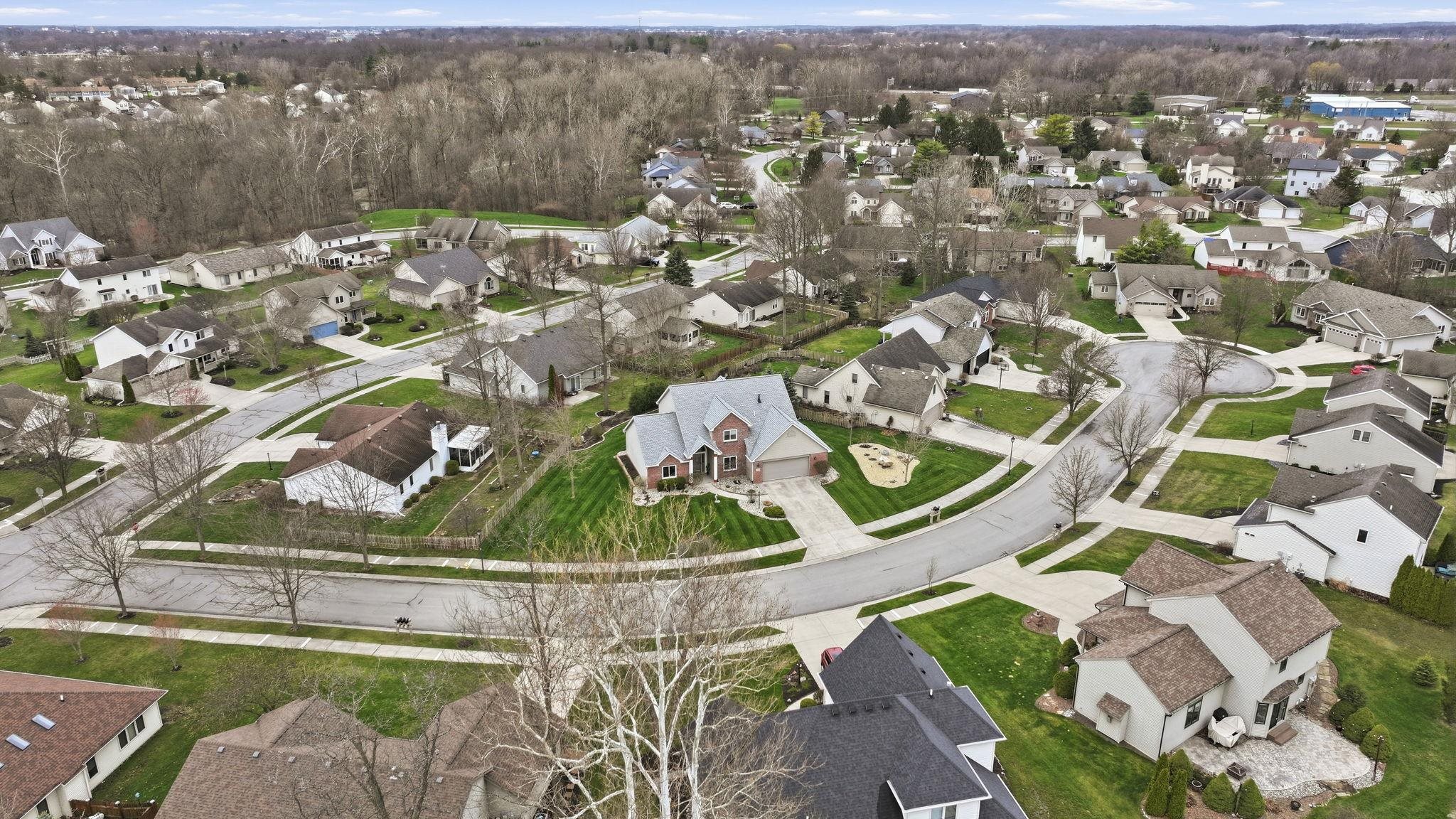 Aerial view of property's location with nearby suburban area