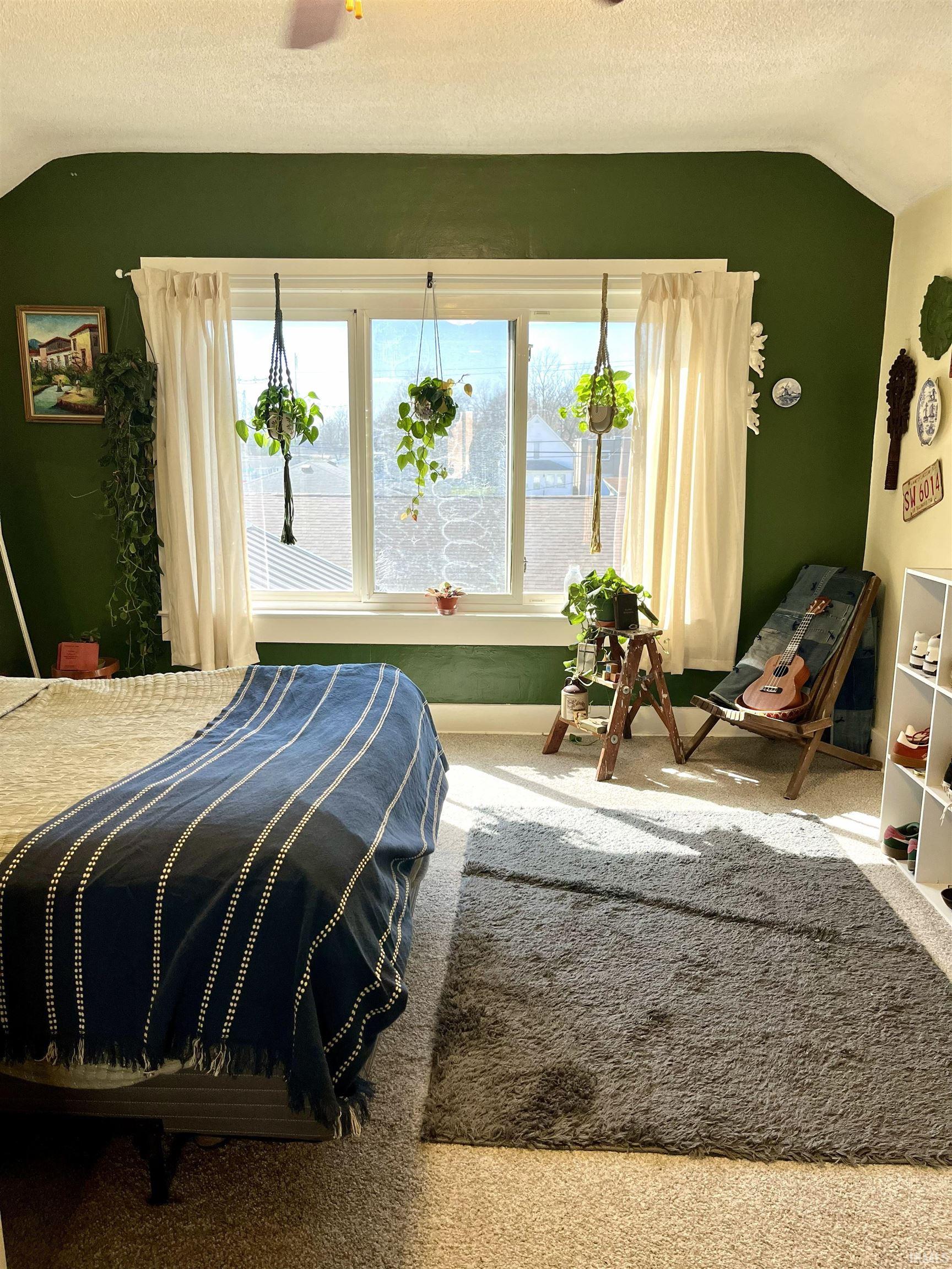 Bedroom featuring carpet and baseboards