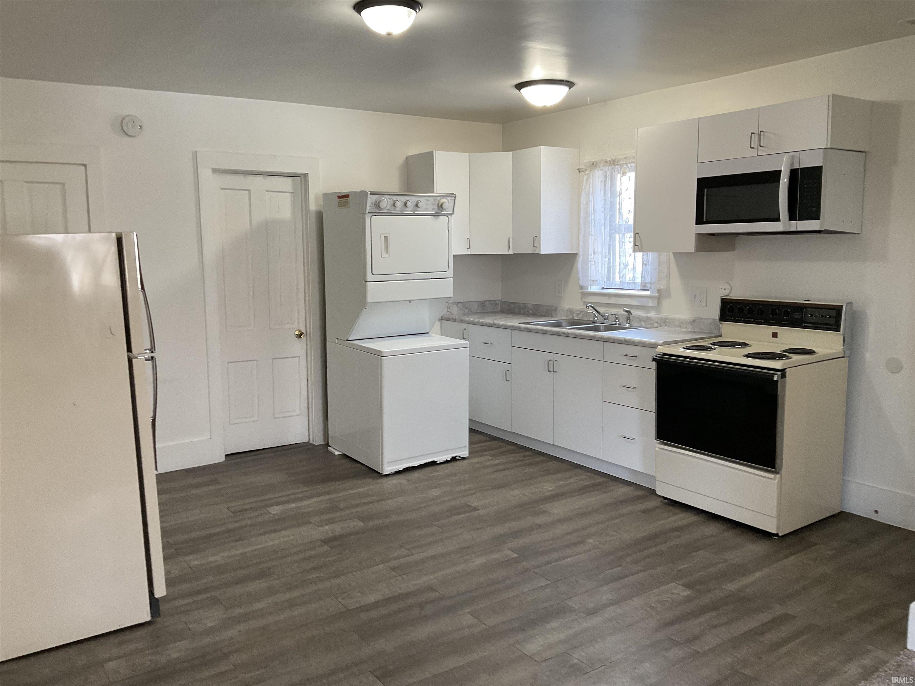 Kitchen featuring washer and dryer, new countertops and cabinets