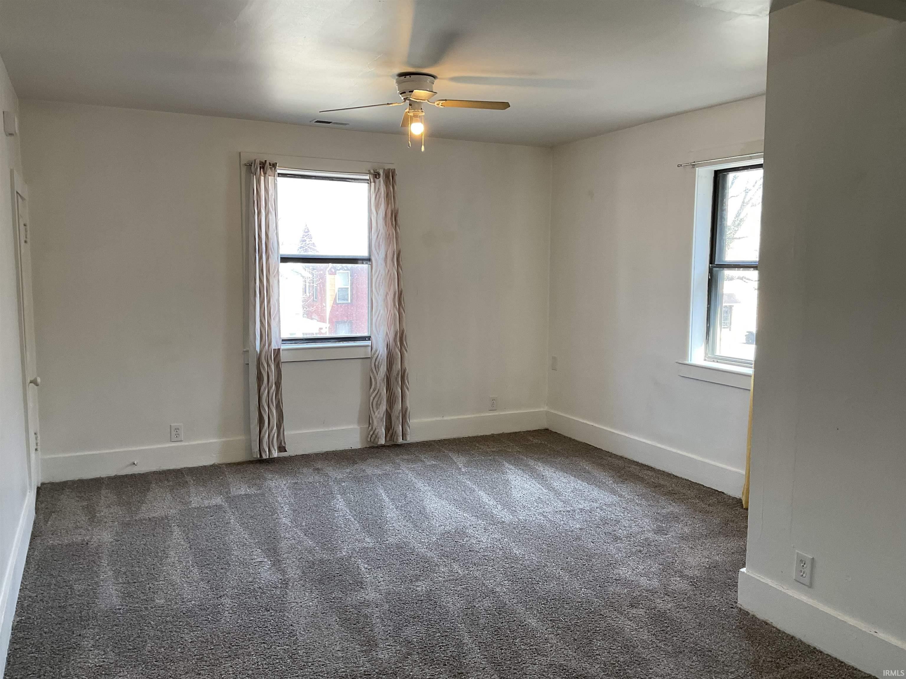 Spacious living room with natural light from 2 windows.