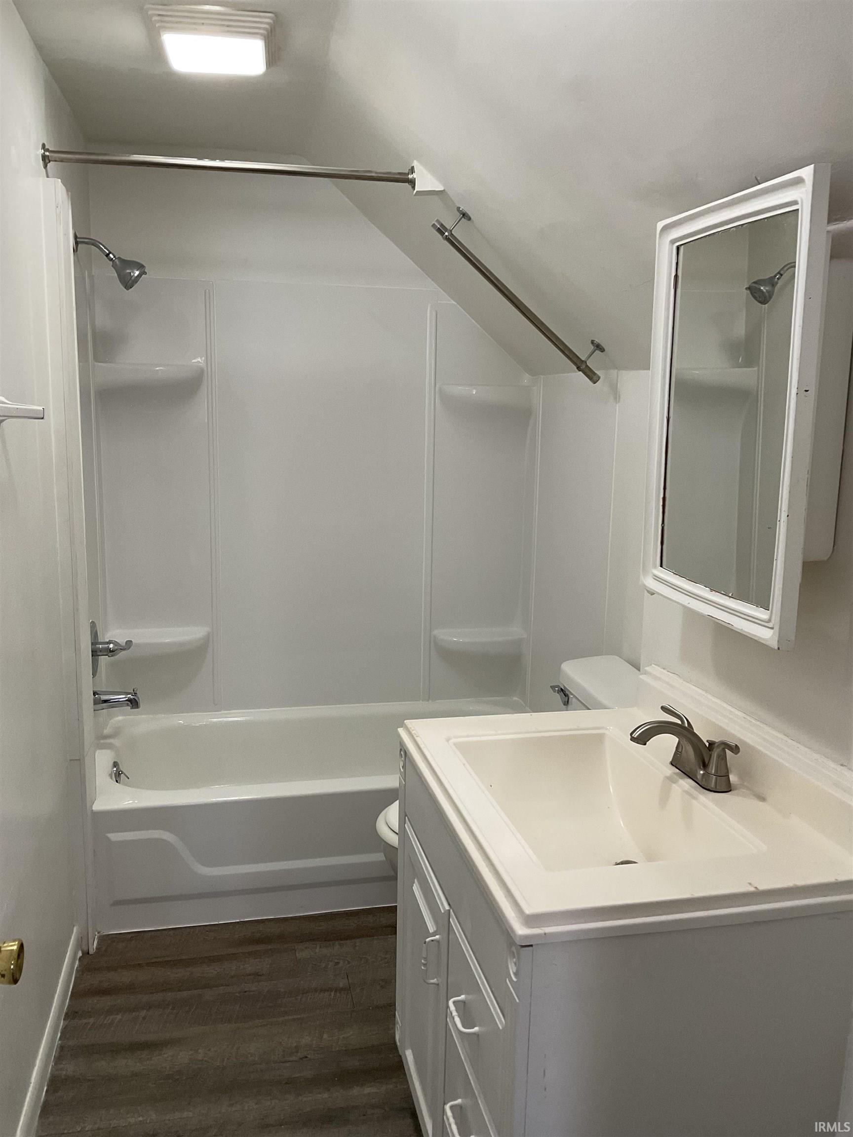 Bathroom with vanity and tub / shower combination.