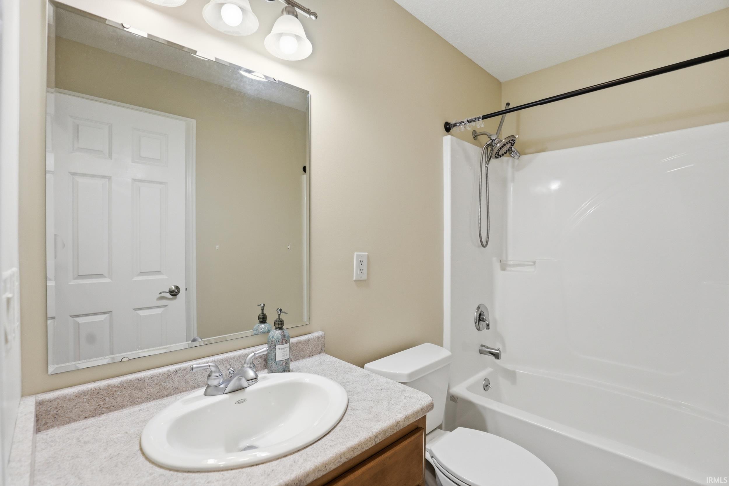 Bathroom with vanity and bathing tub / shower combination
