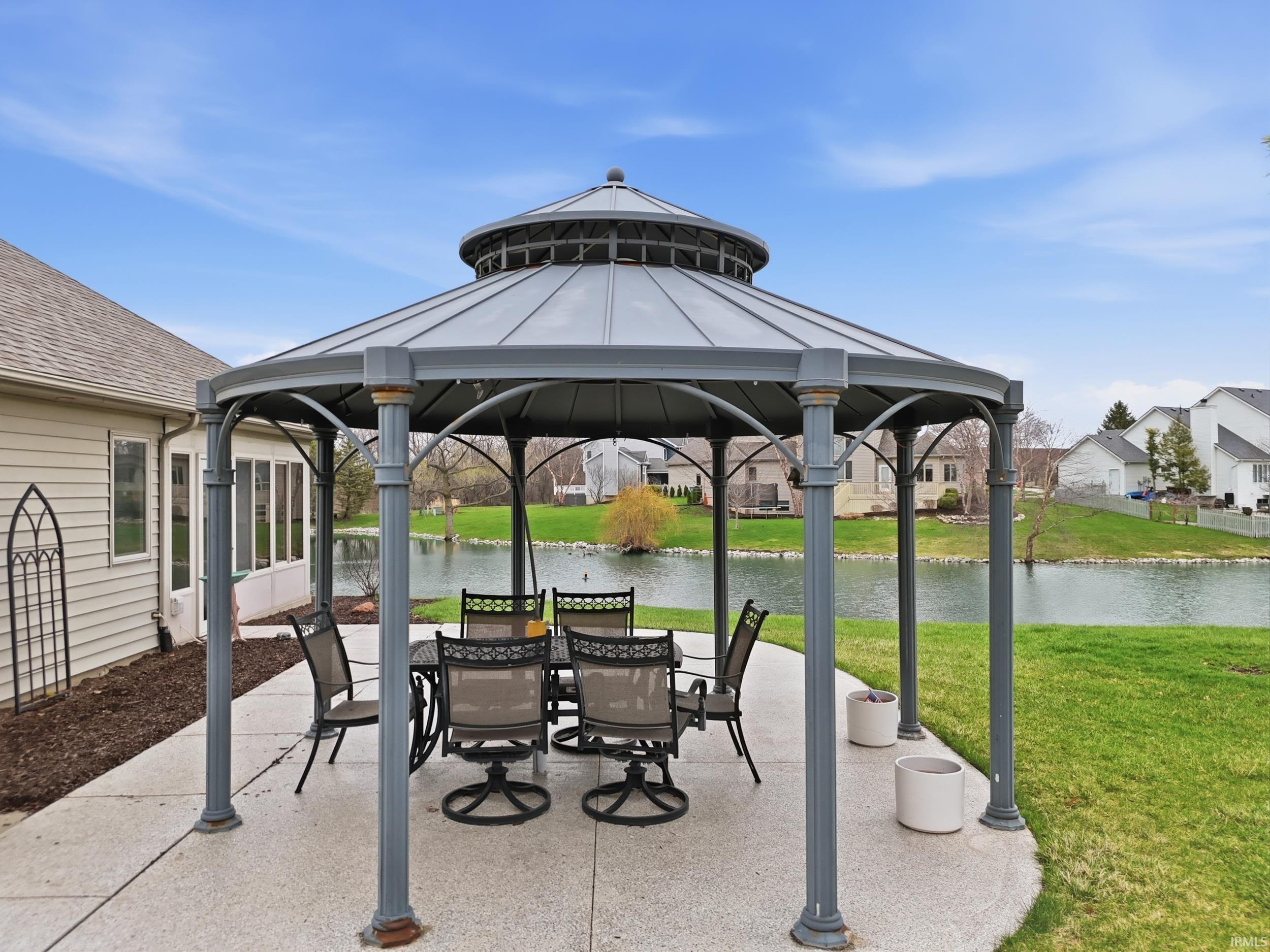 View of patio / terrace featuring a gazebo, a water view, and outdoor dining area