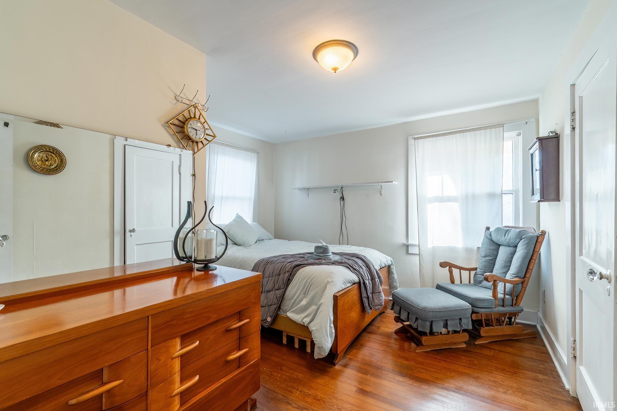 Bedroom with dark wood-style floors