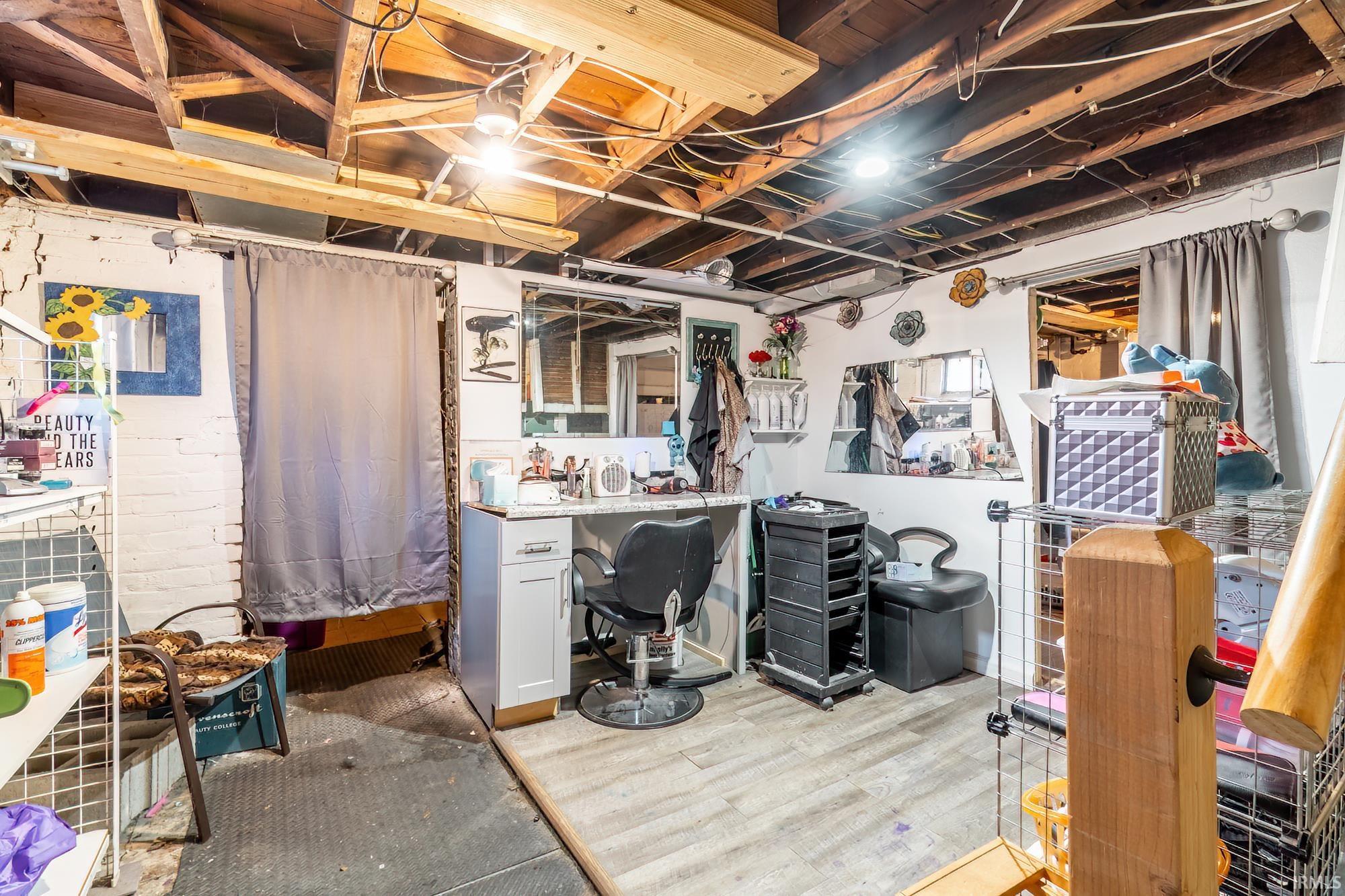 Unfinished below grade area featuring wood finished floors