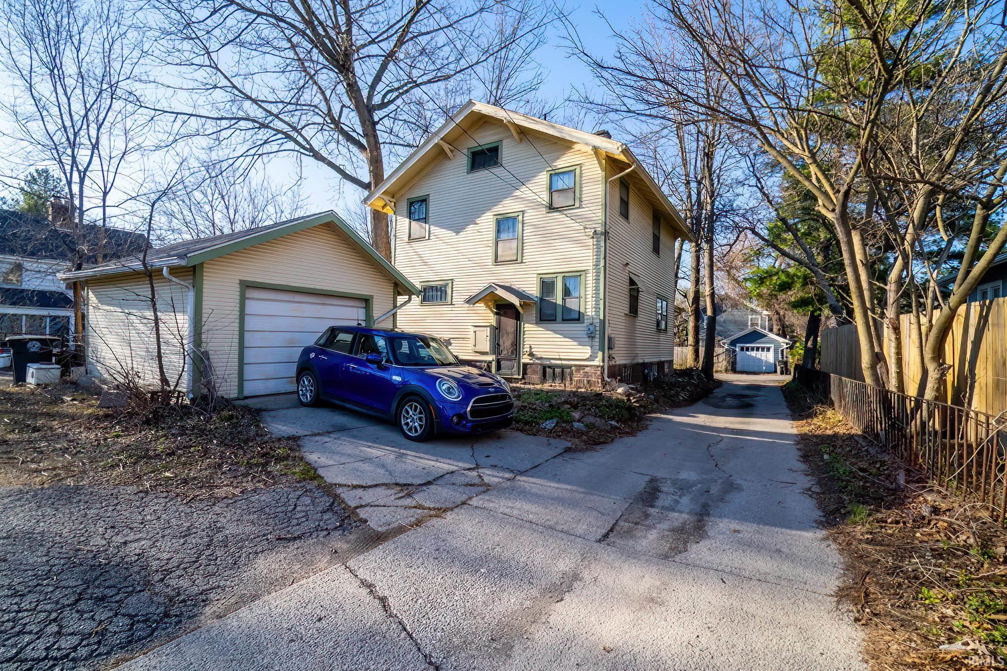 View of front facade with an outbuilding and a detached garage