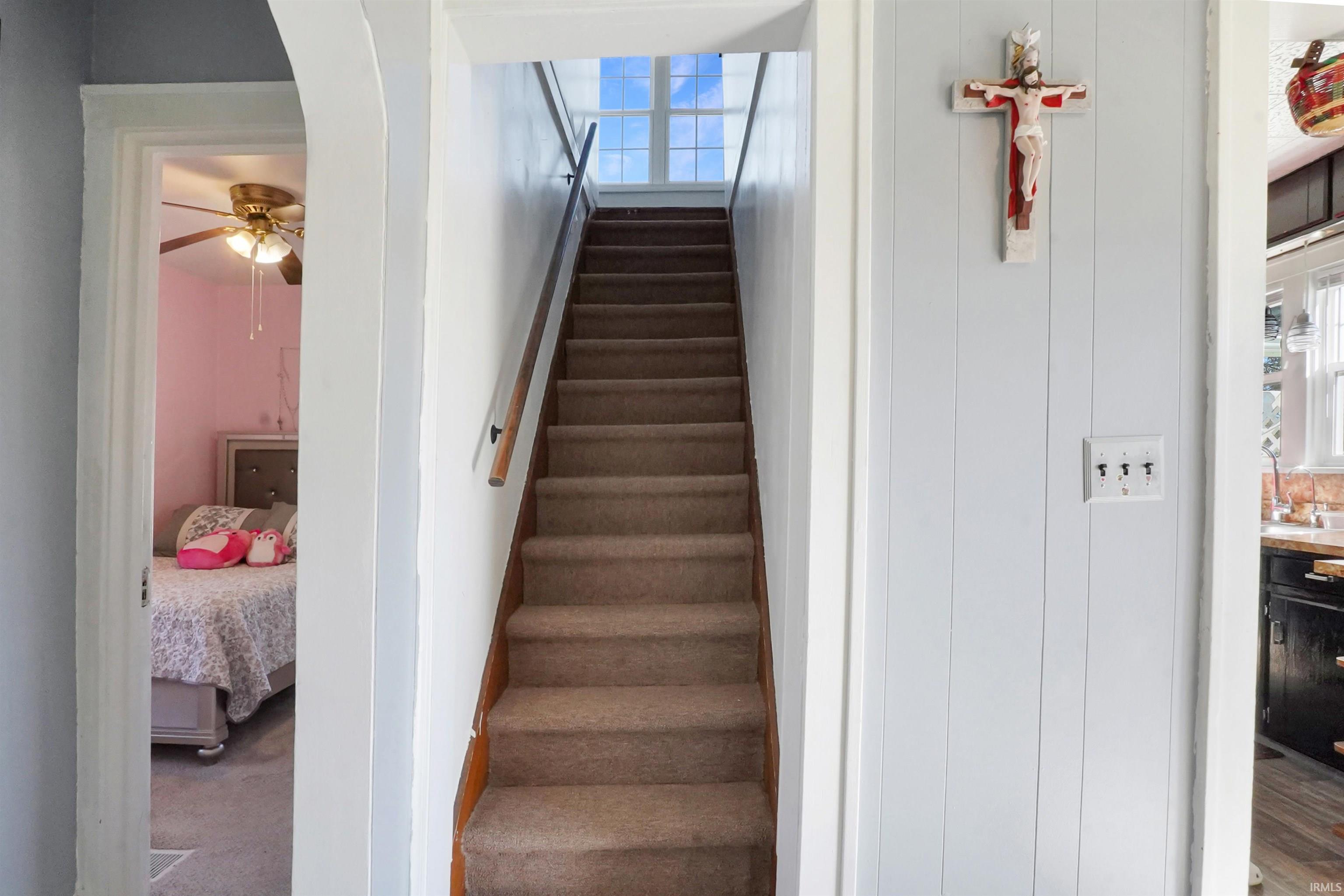 Stairway with a ceiling fan