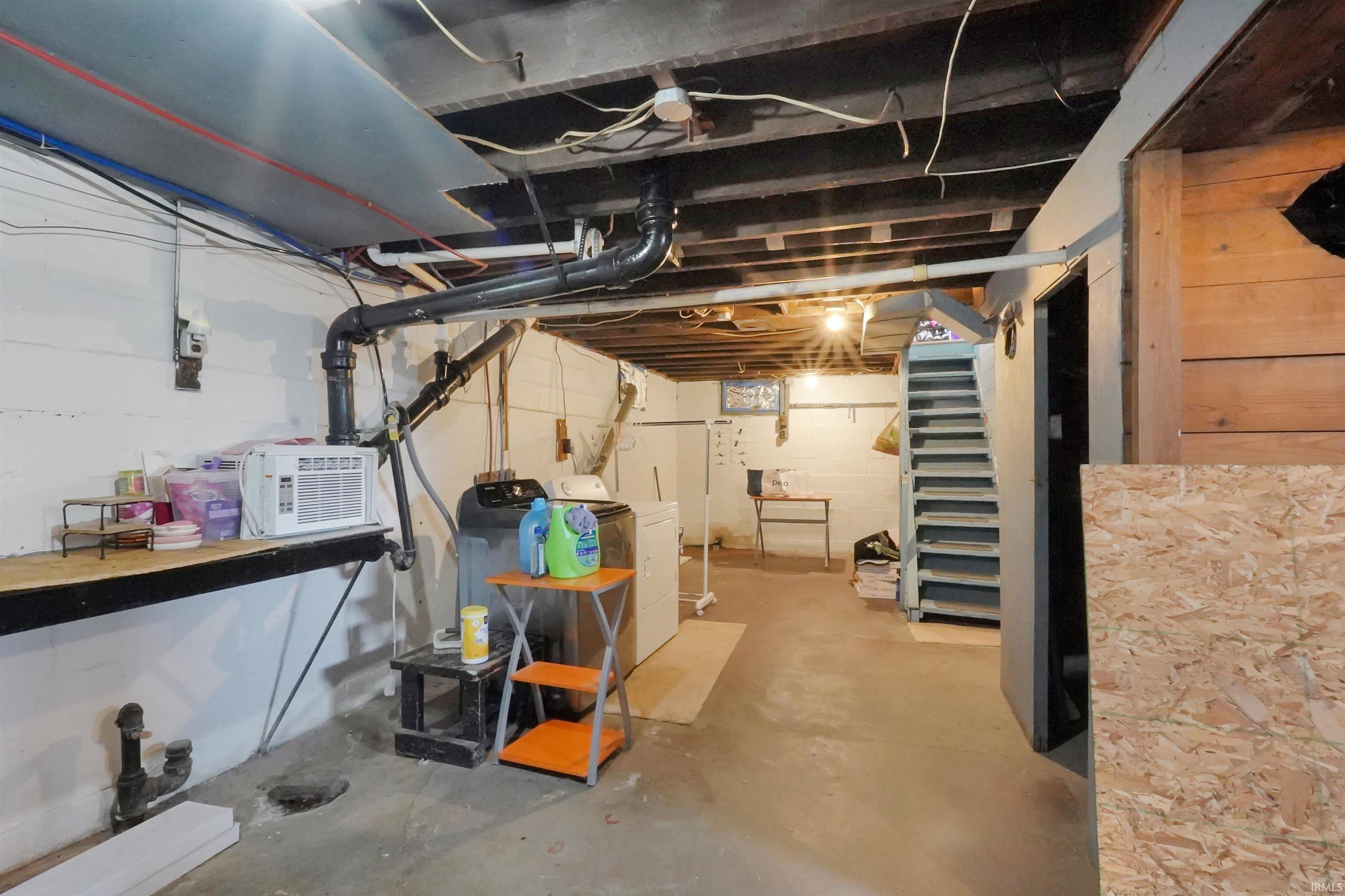 Unfinished basement featuring washer / clothes dryer