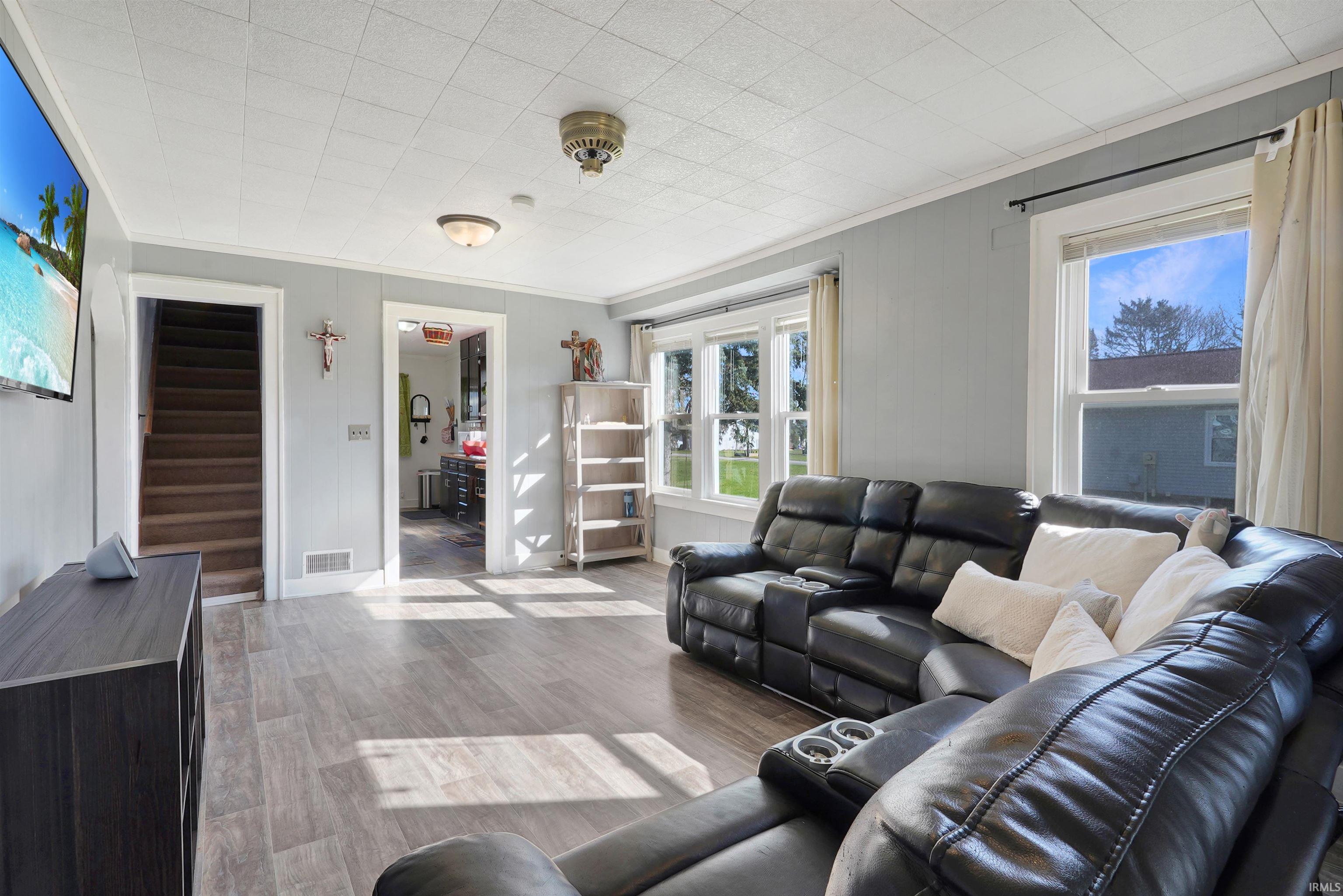Living room featuring wood finished floors and ornamental molding