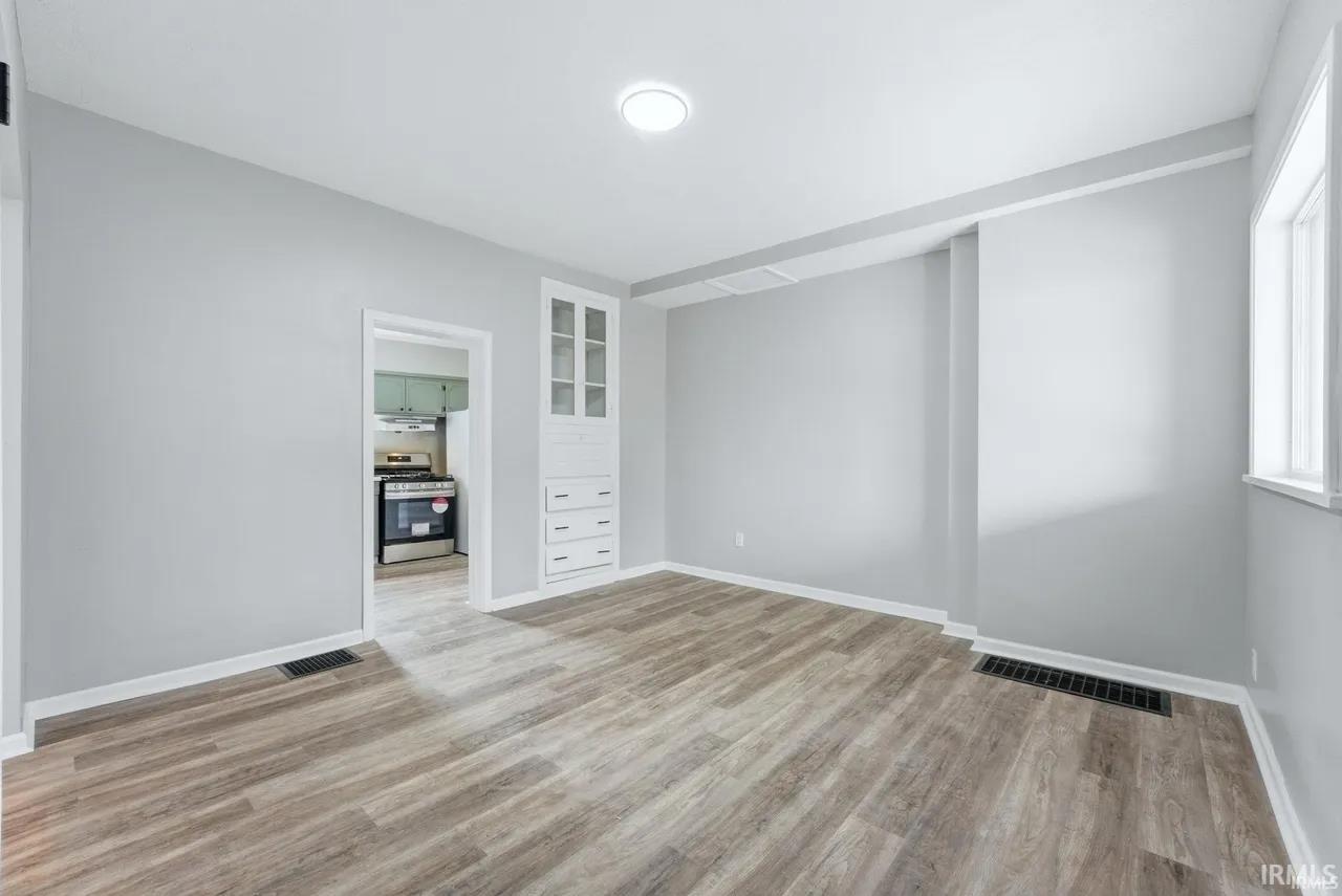 Empty room with light wood-style flooring and baseboards