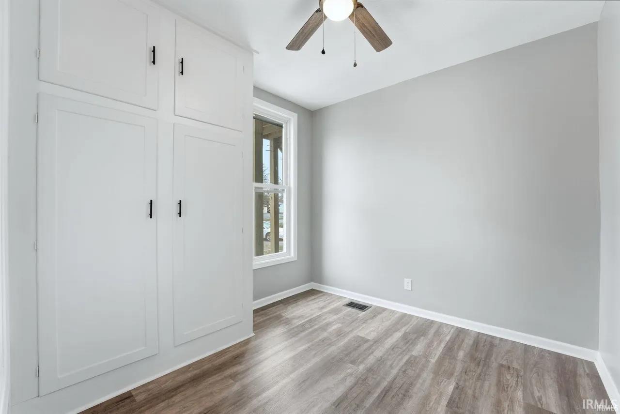 Unfurnished bedroom featuring light wood-style flooring and a ceiling fan