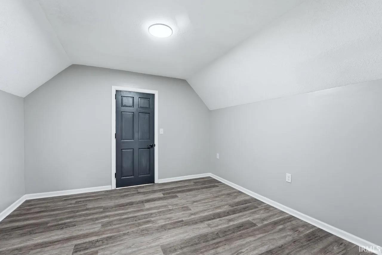 Additional living space with wood finished floors and baseboards
