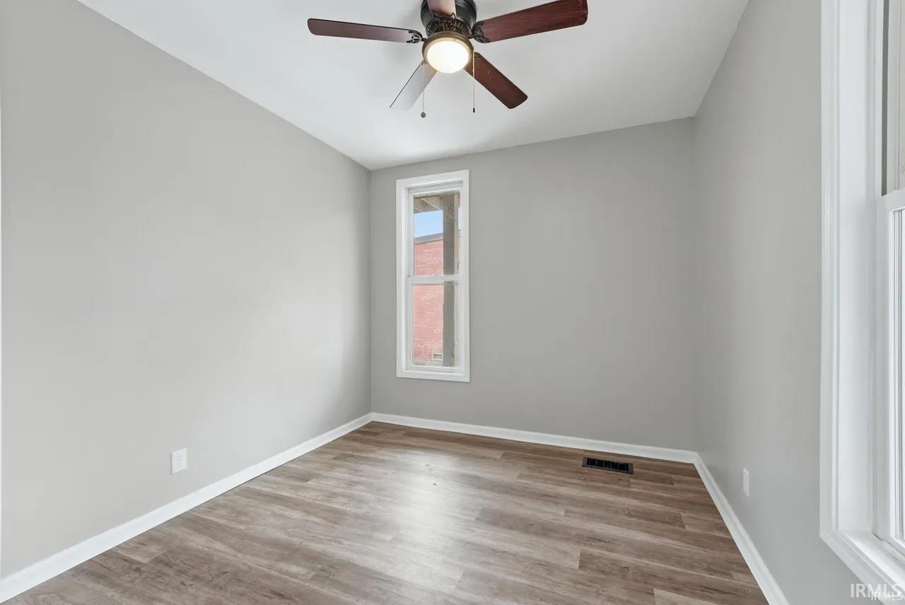 Unfurnished room with light wood-style floors and ceiling fan
