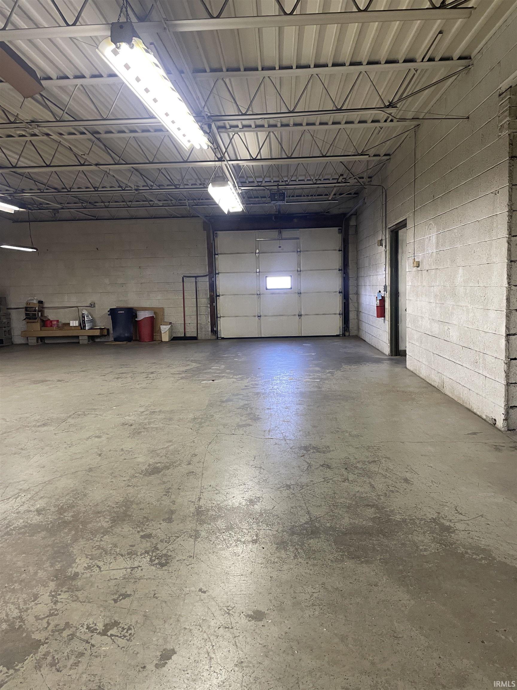Garage featuring concrete block wall