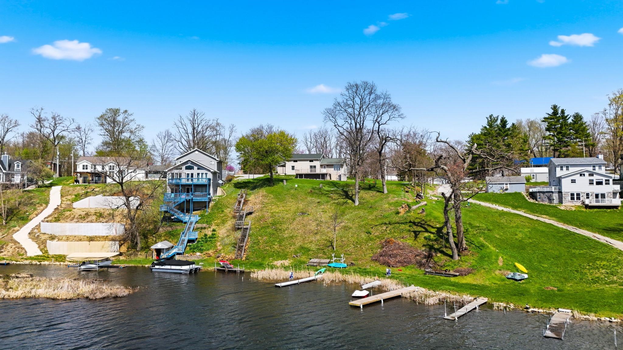 Aerial perspective of suburban area featuring a large body of water