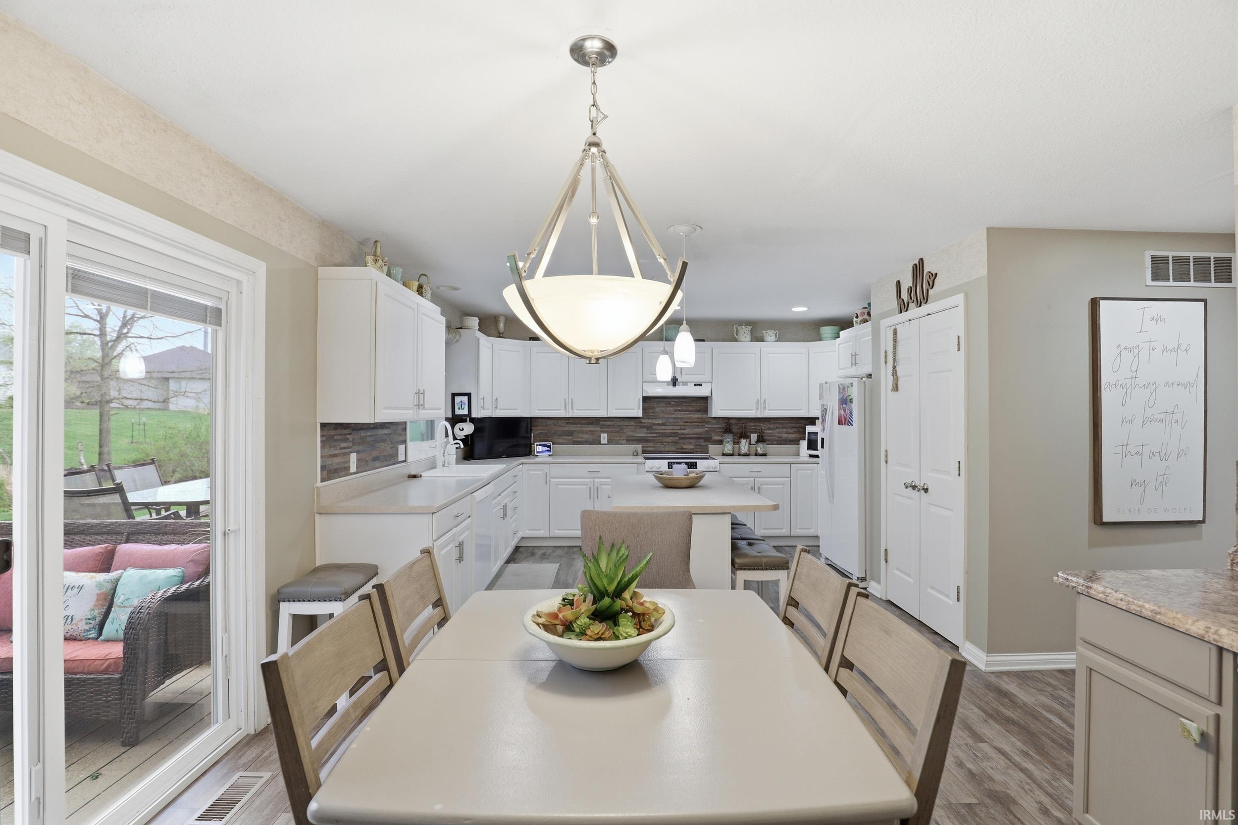 Dining space with light wood-type flooring and baseboards