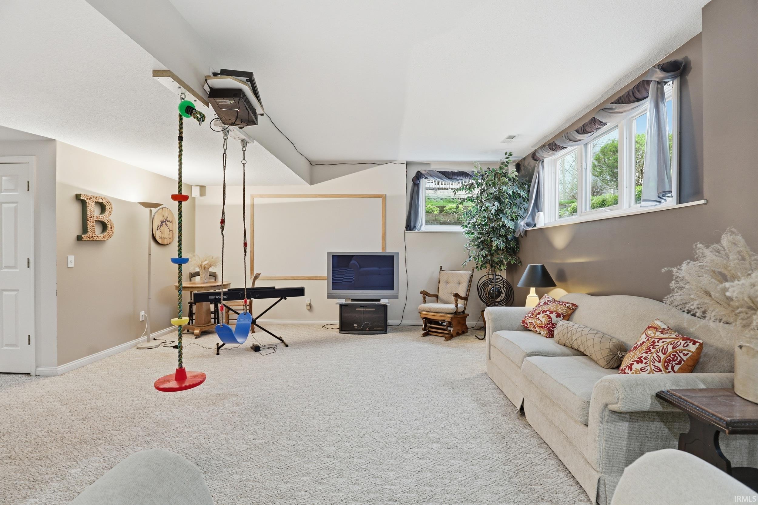 Living area with carpet and baseboards