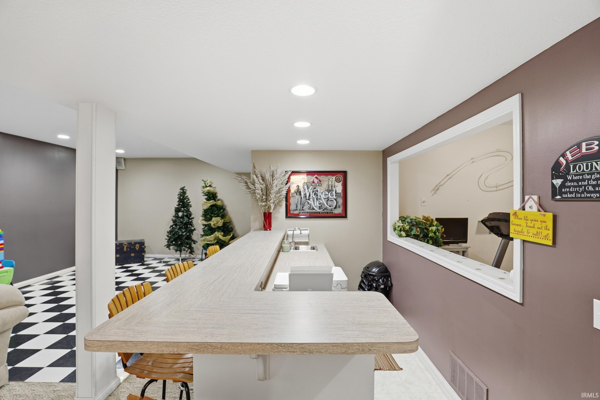 Office area with light flooring and recessed lighting