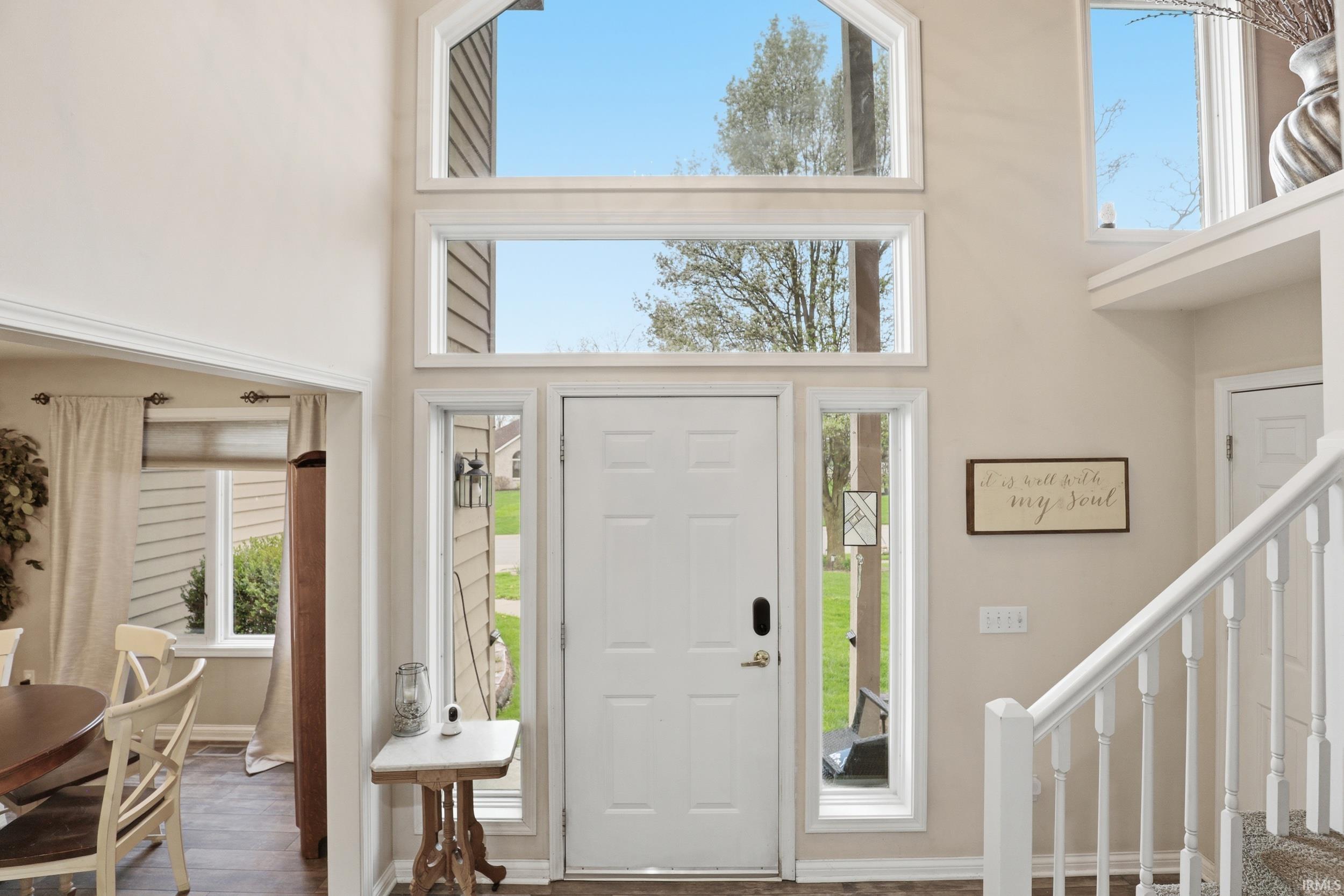 Foyer entrance featuring a high ceiling and wood finished floors