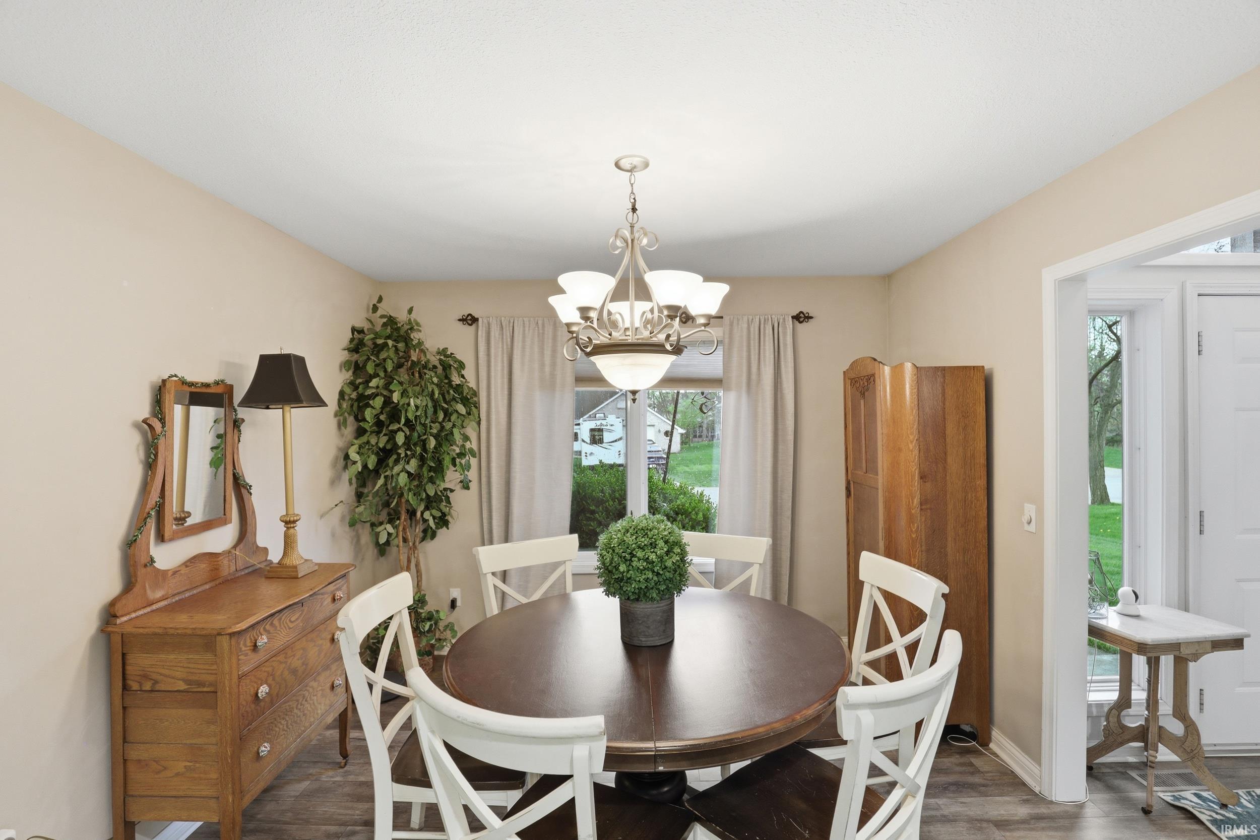 Dining space featuring suspended lighting and wood finished floors