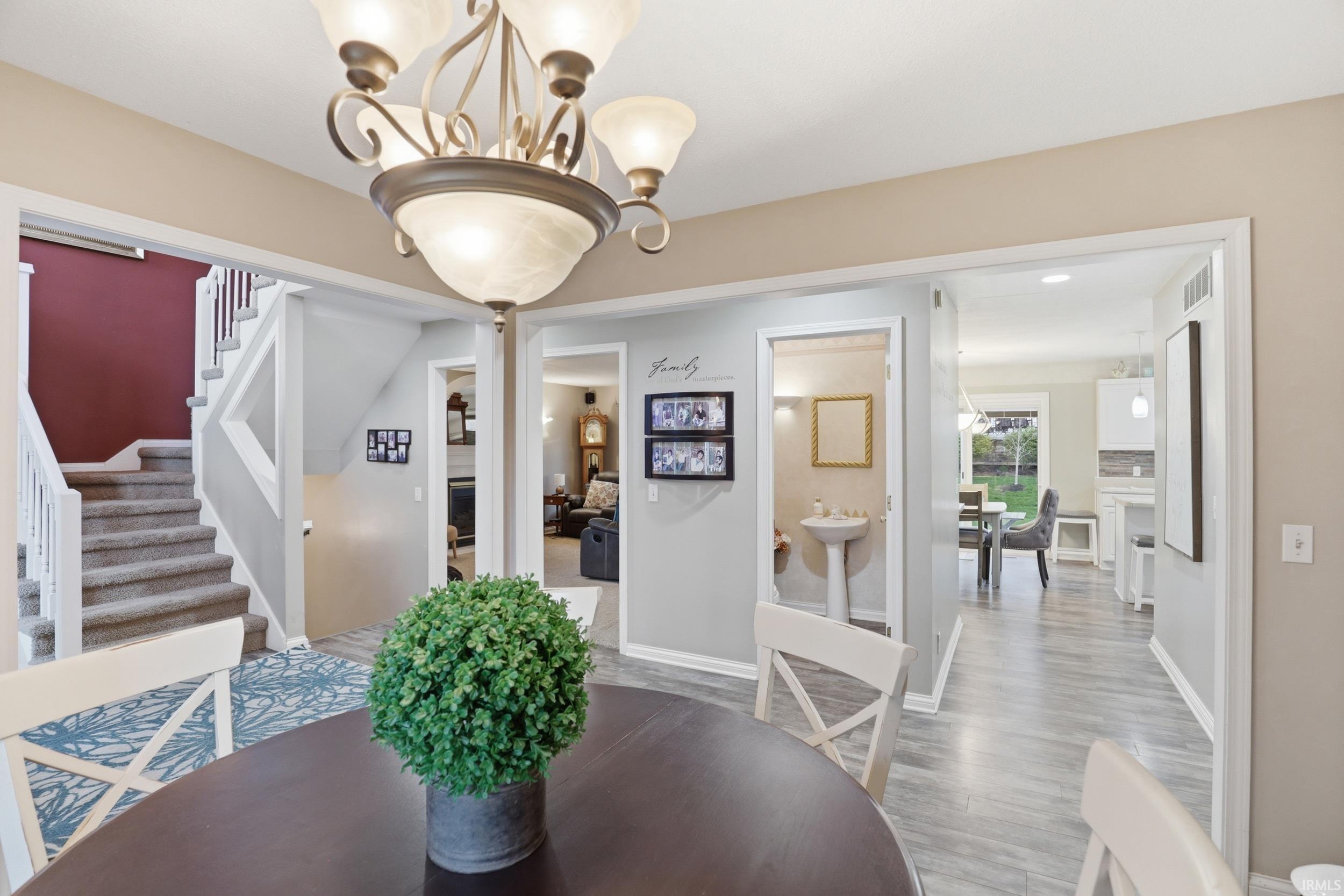 Dining room with suspended lighting and wood finished floors