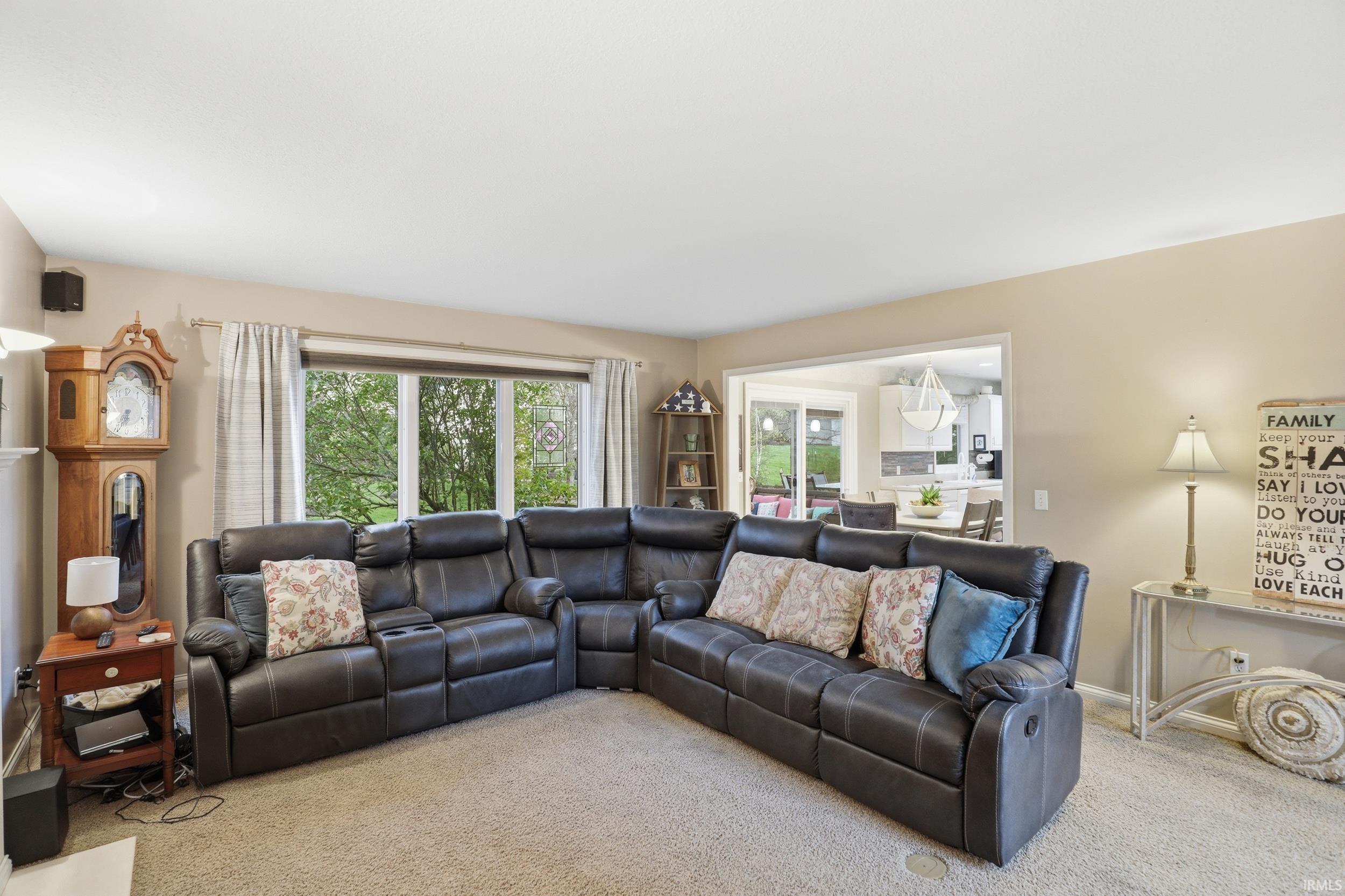 Carpeted living area with plenty of natural light