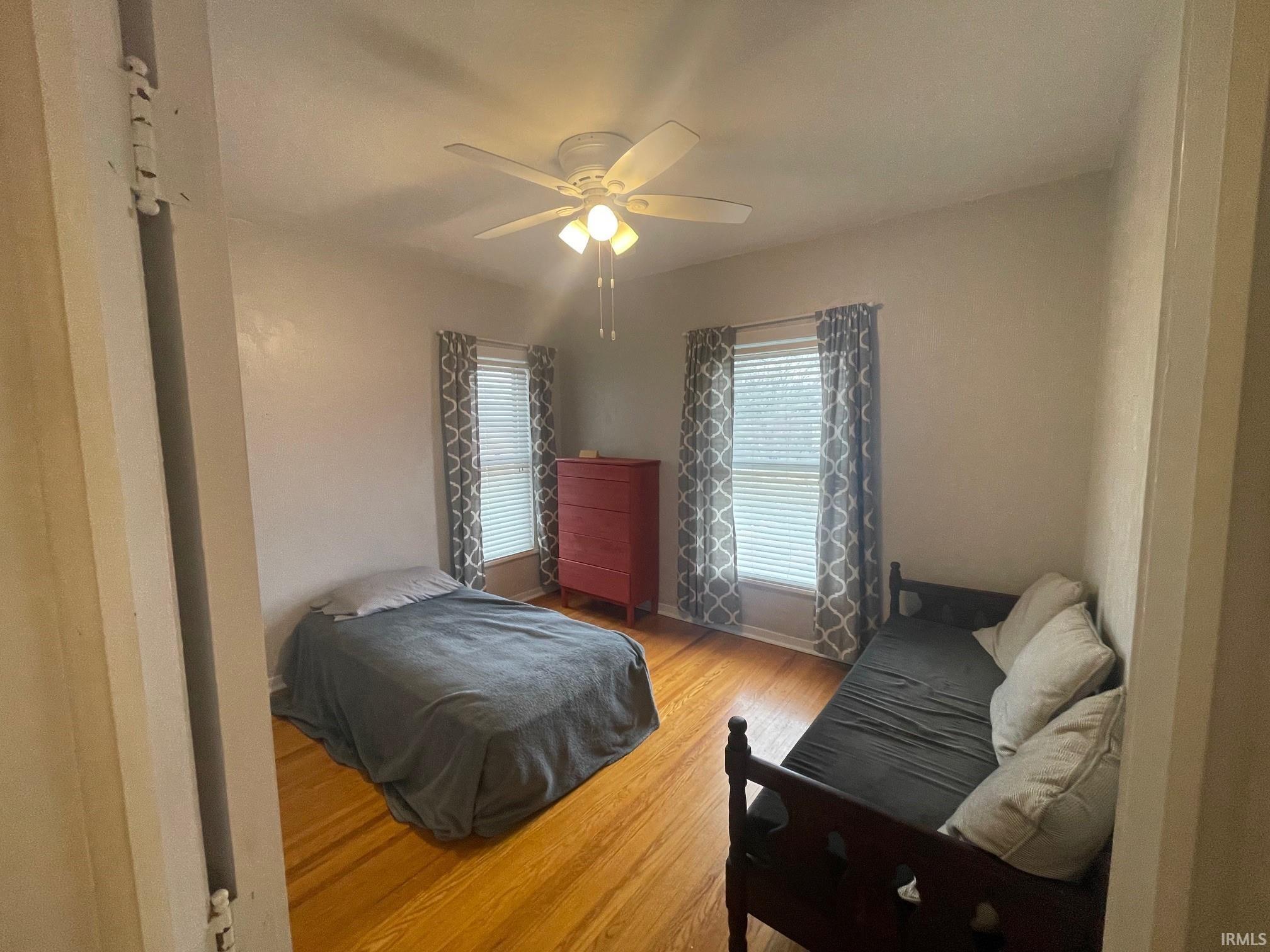 Bedroom featuring light hardwood floors and ceiling fan
