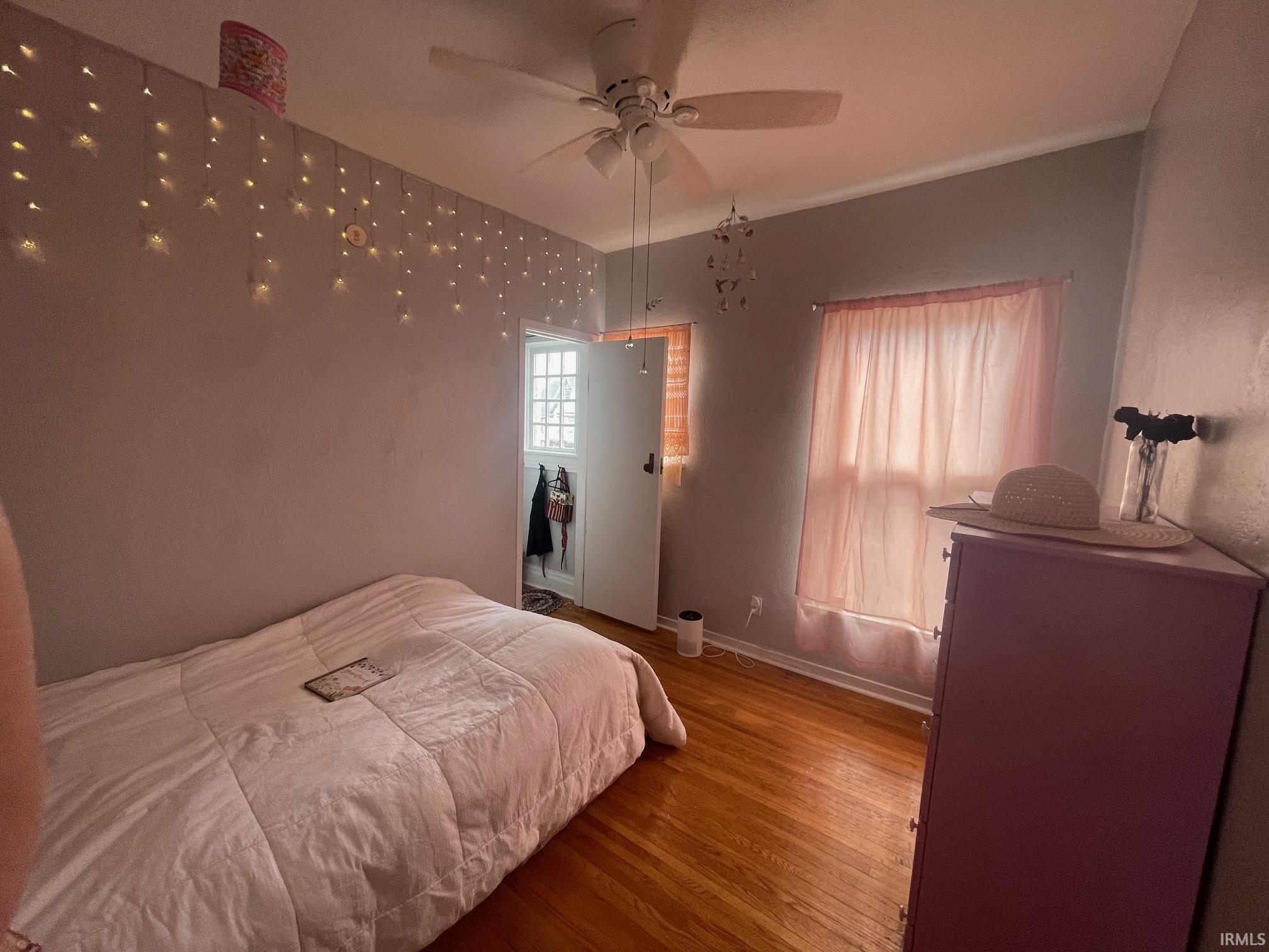 Bedroom featuring hardwood floors and a ceiling fan