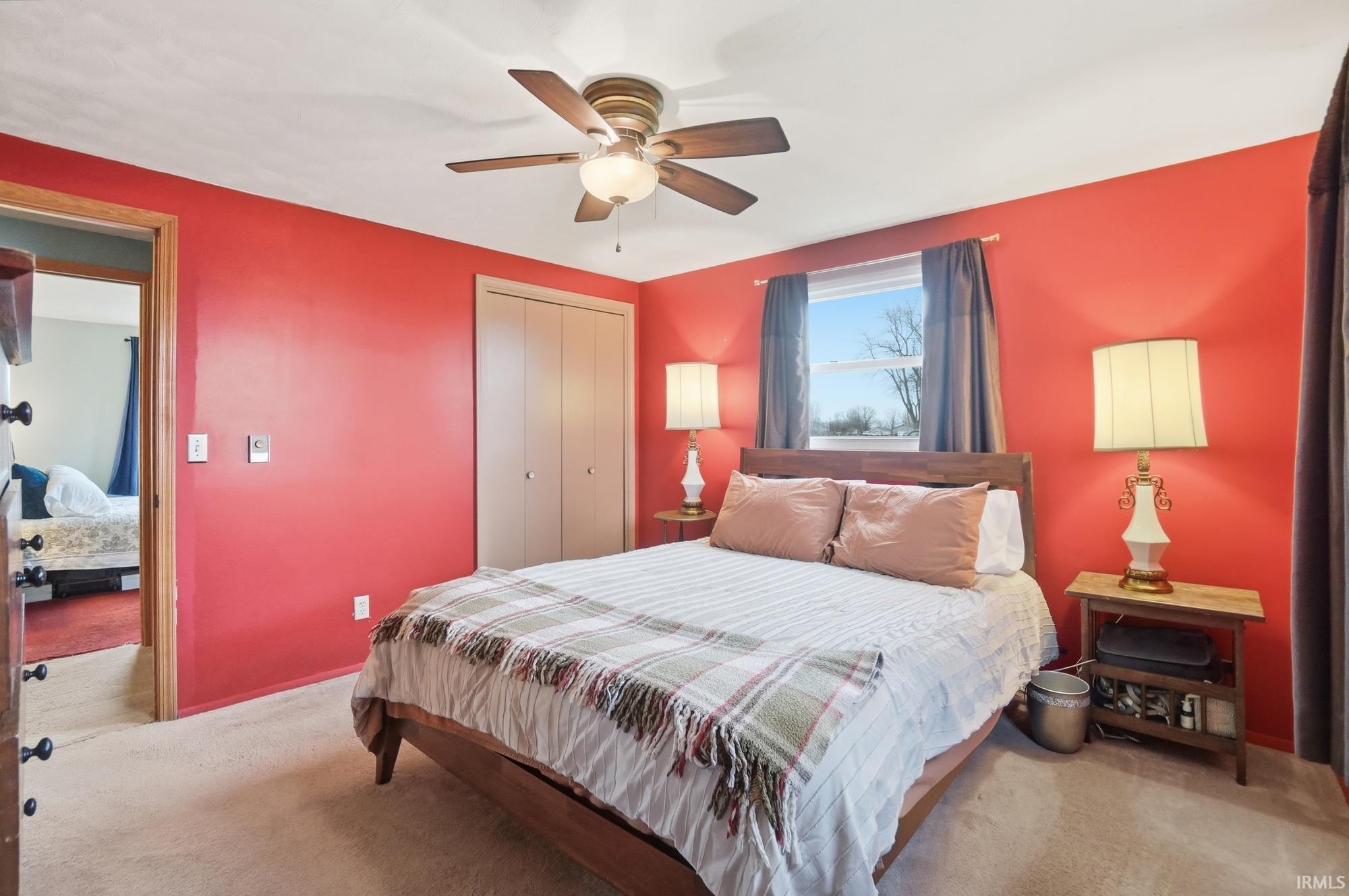Bedroom featuring carpet, a closet, and a ceiling fan