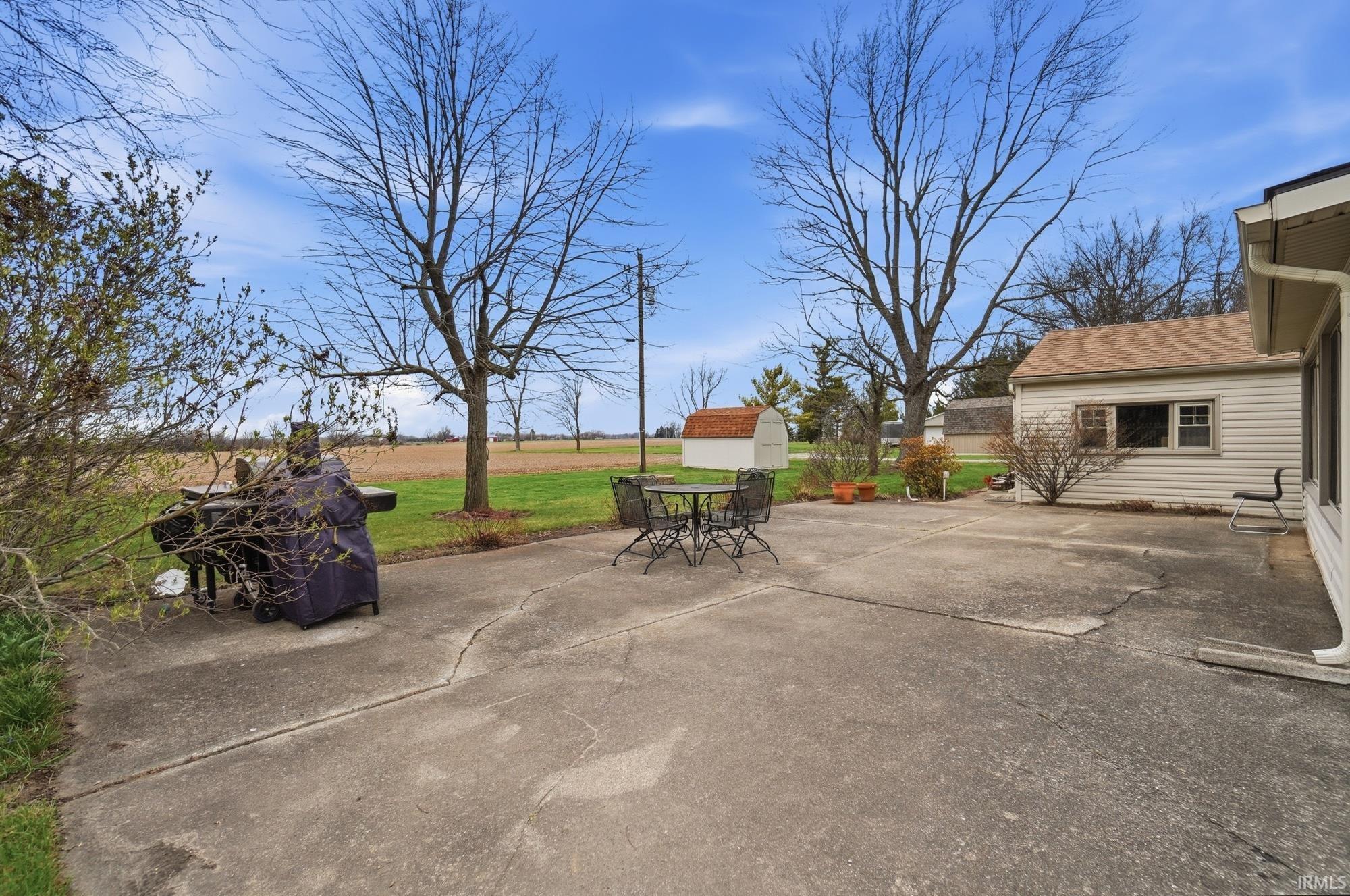 View of patio with a shed and outdoor dining area