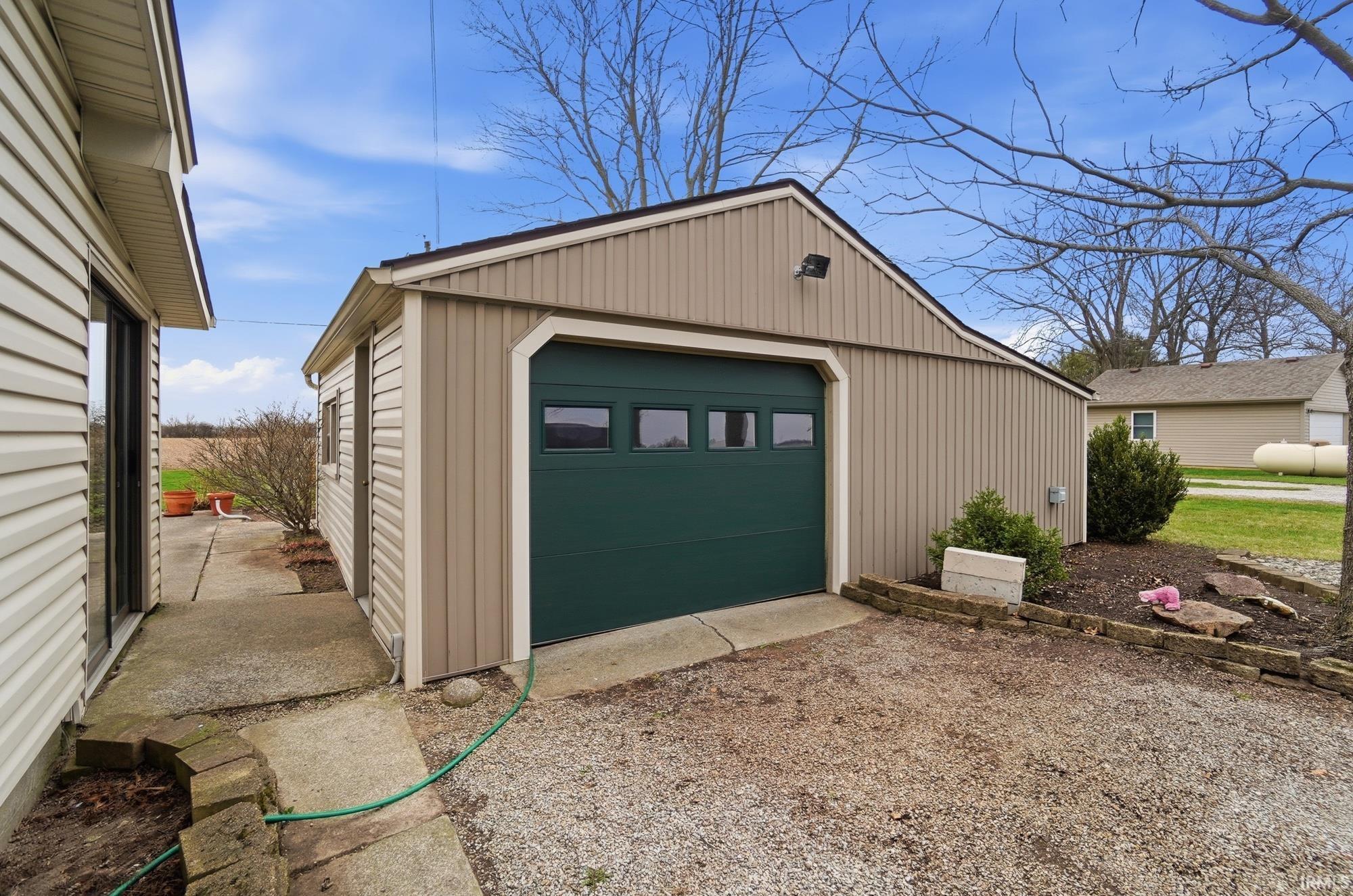 Detached garage with gravel driveway